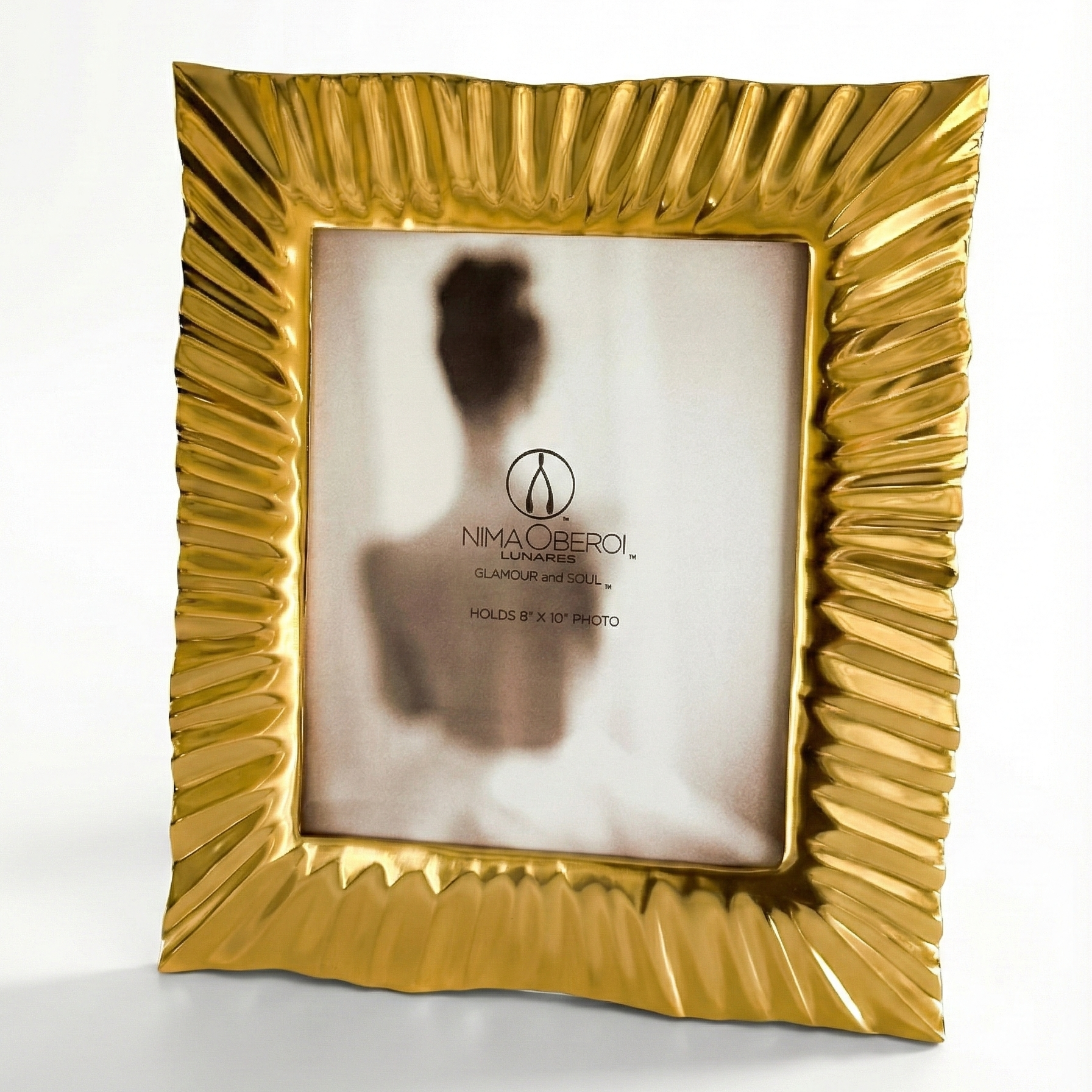 Gold photo frame with ribbed design on a white background