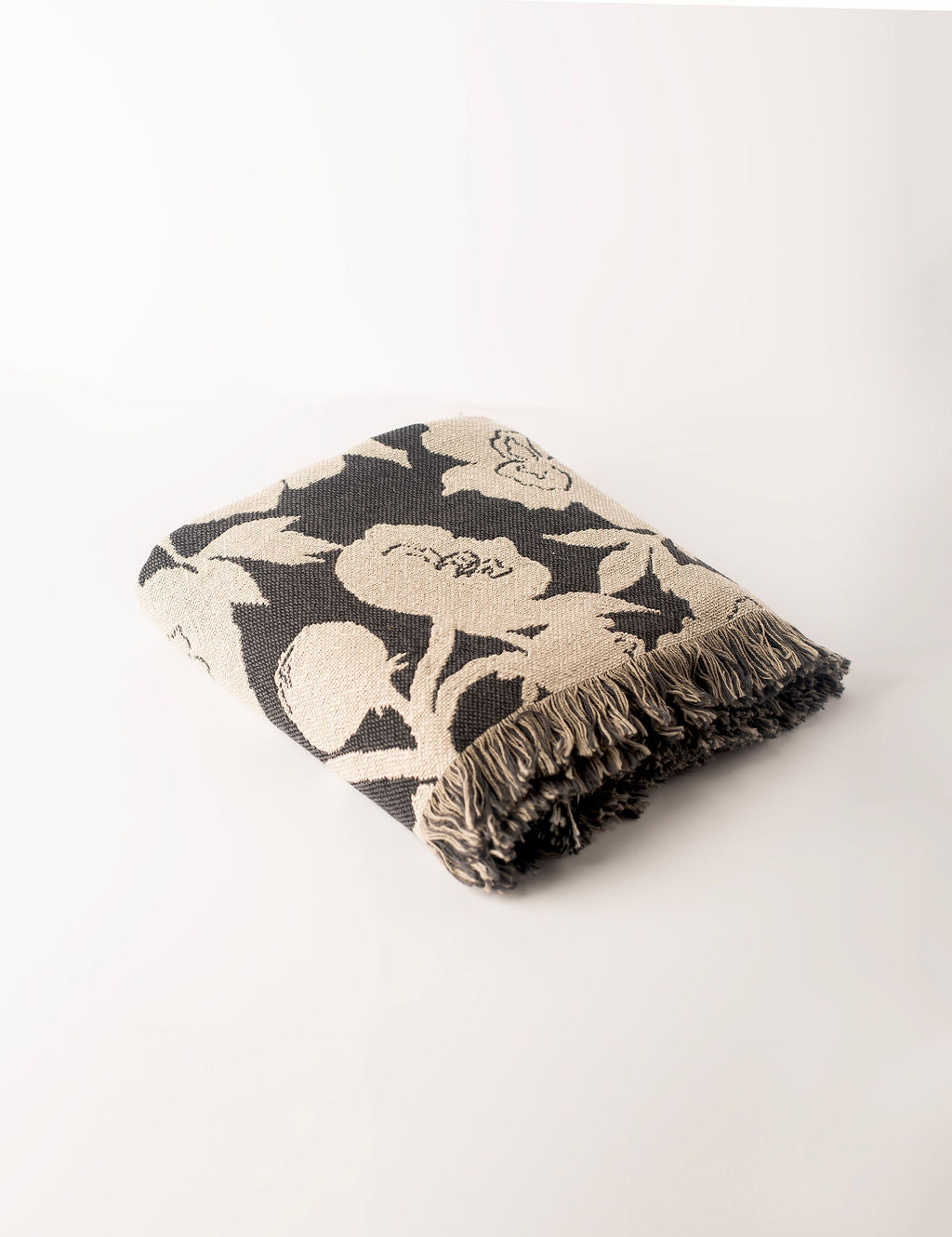 Folded Addy Tuffet neutral floral reversible jacquard woven throw blanket