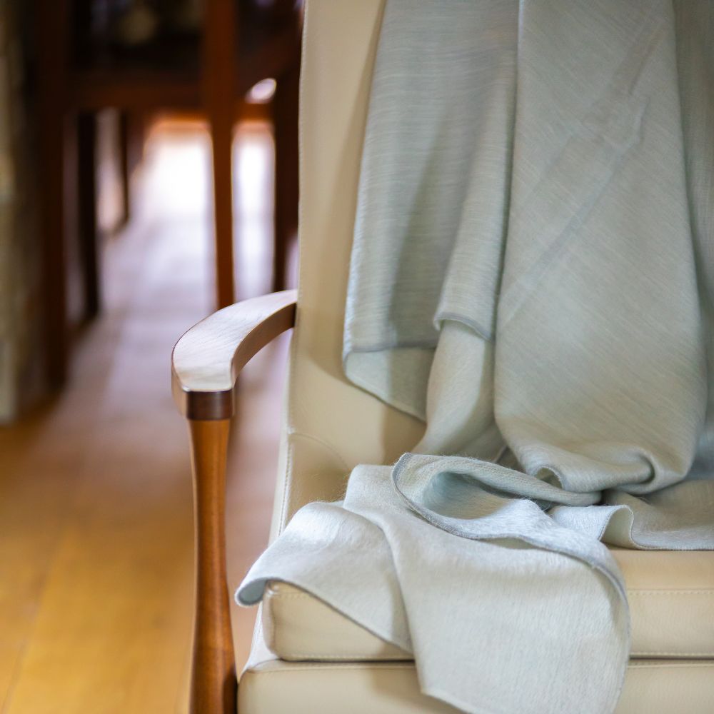 Light gray handwoven throw on sofa