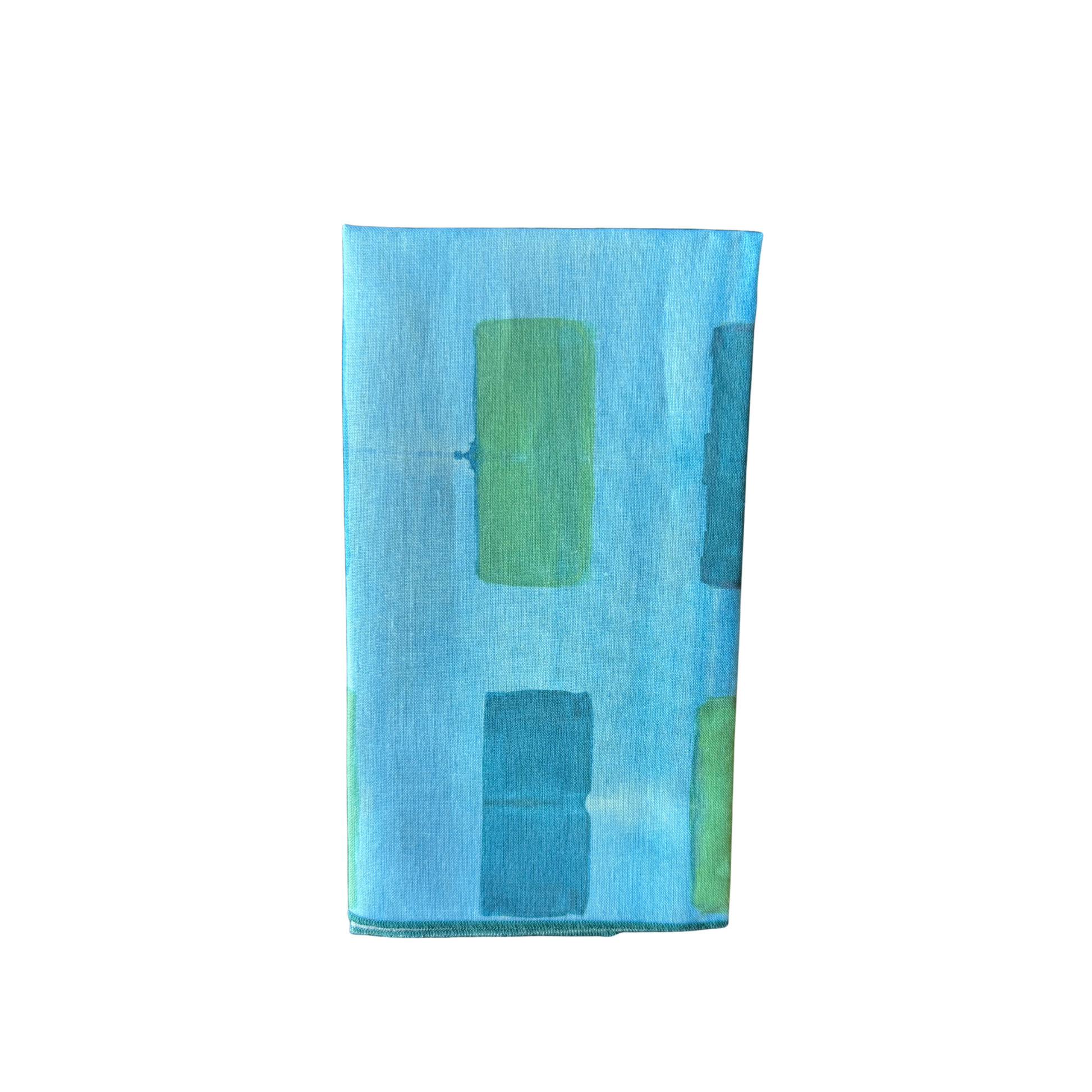 Blue Tapestry linen dinner napkin folded on place setting - Goldie Home