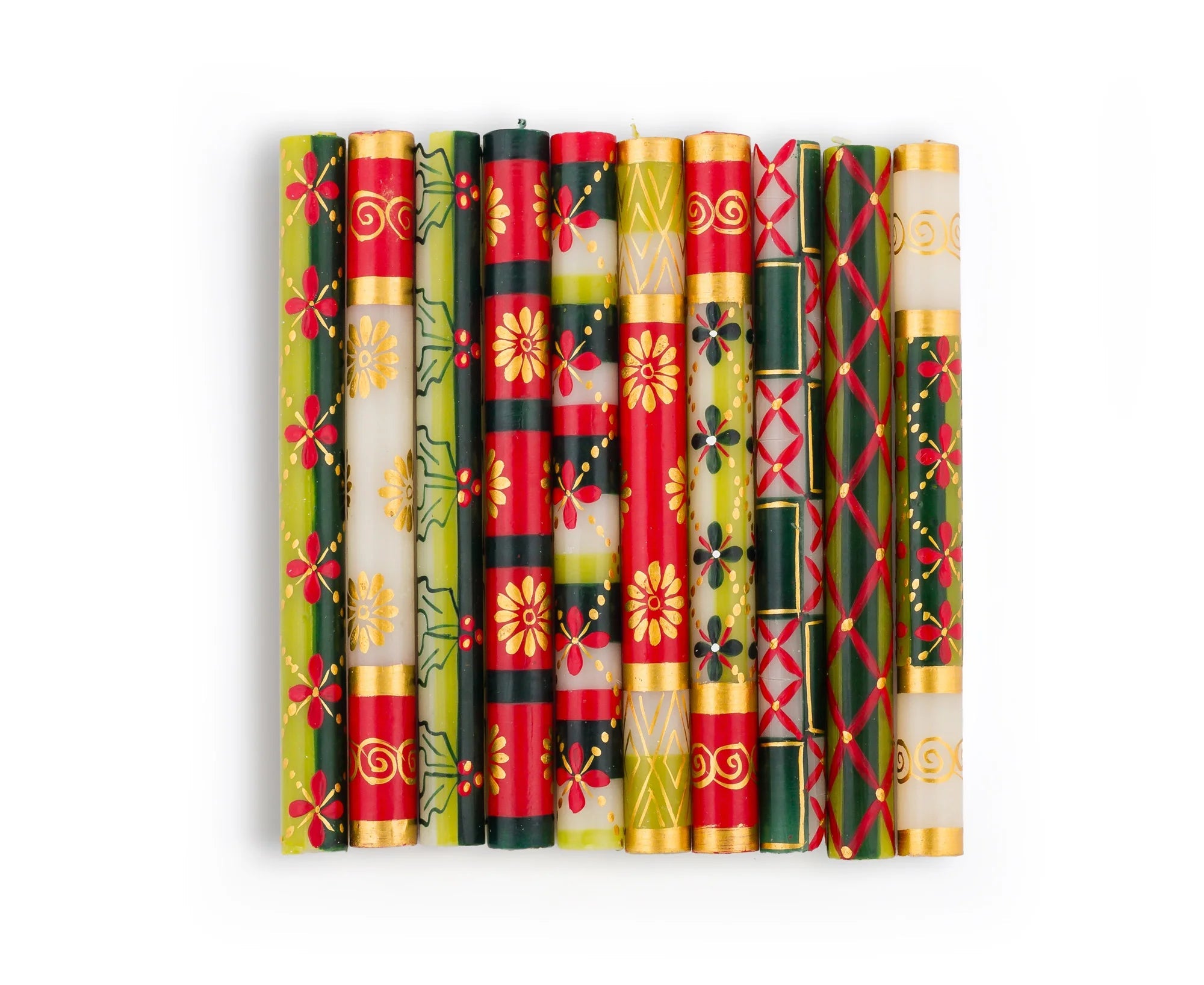 10 Christmas dinner tapers in the 10 designs of the Christmas collection. Hand painted in various traditional Christmas patterns in red, dark green, light green and gold on white tapers.