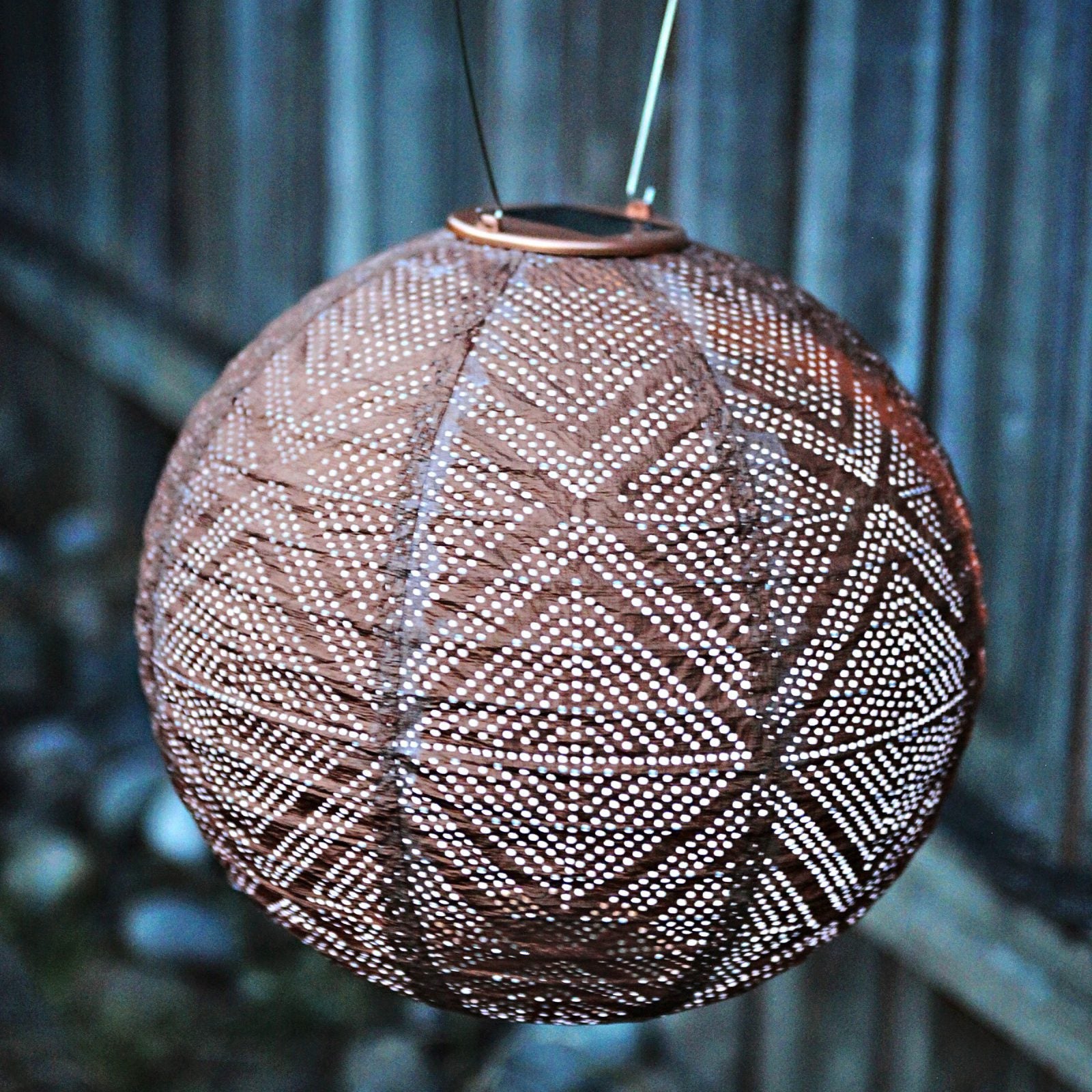 Soji Stella Market 12" Tyvek Solar Lantern glowing at night