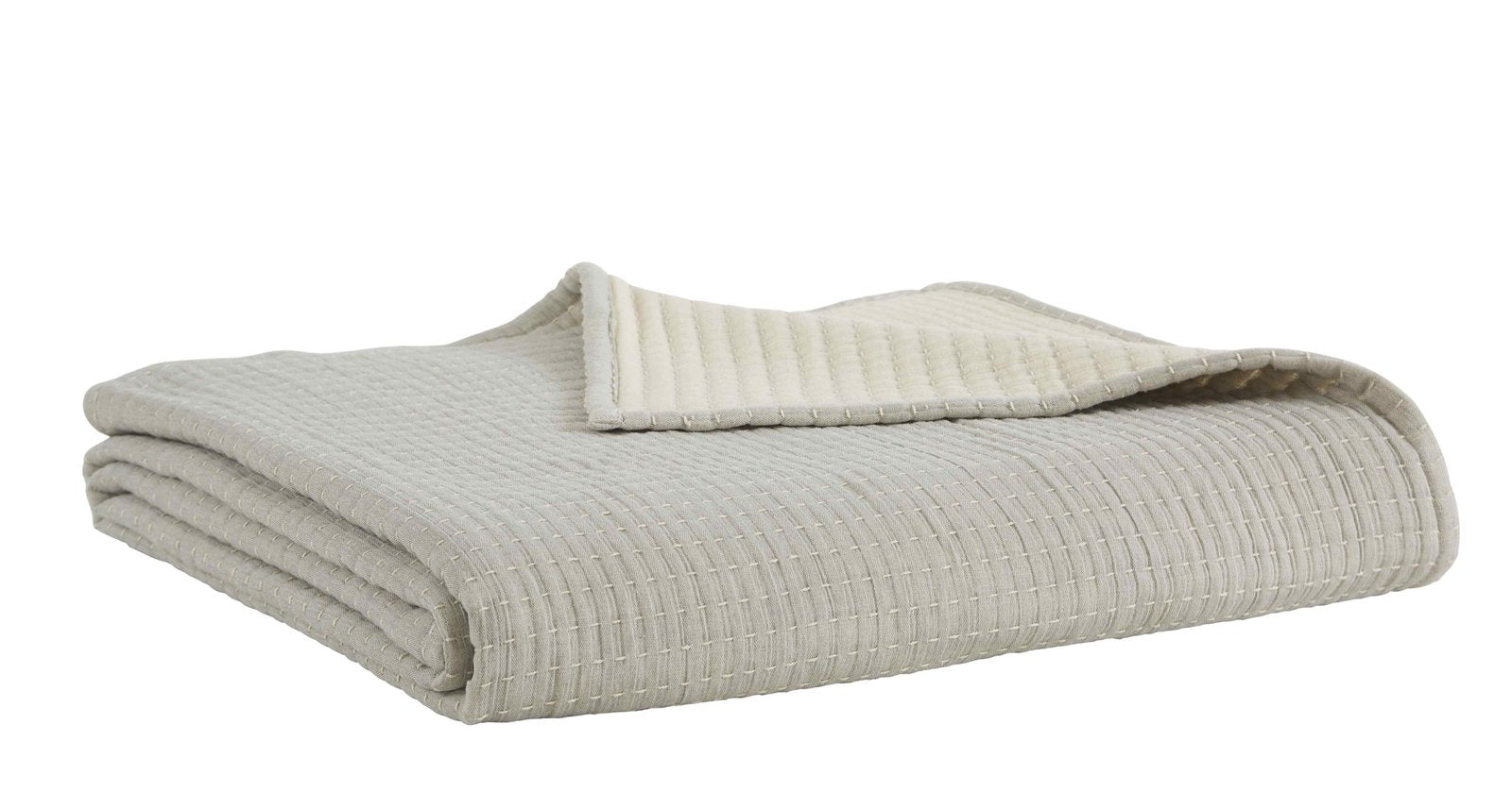 BT-107-9496_3|Cream textured reversible quilt blanket, folded neatly, showcasing soft cream reverse for cozy bed and neutral home decor.