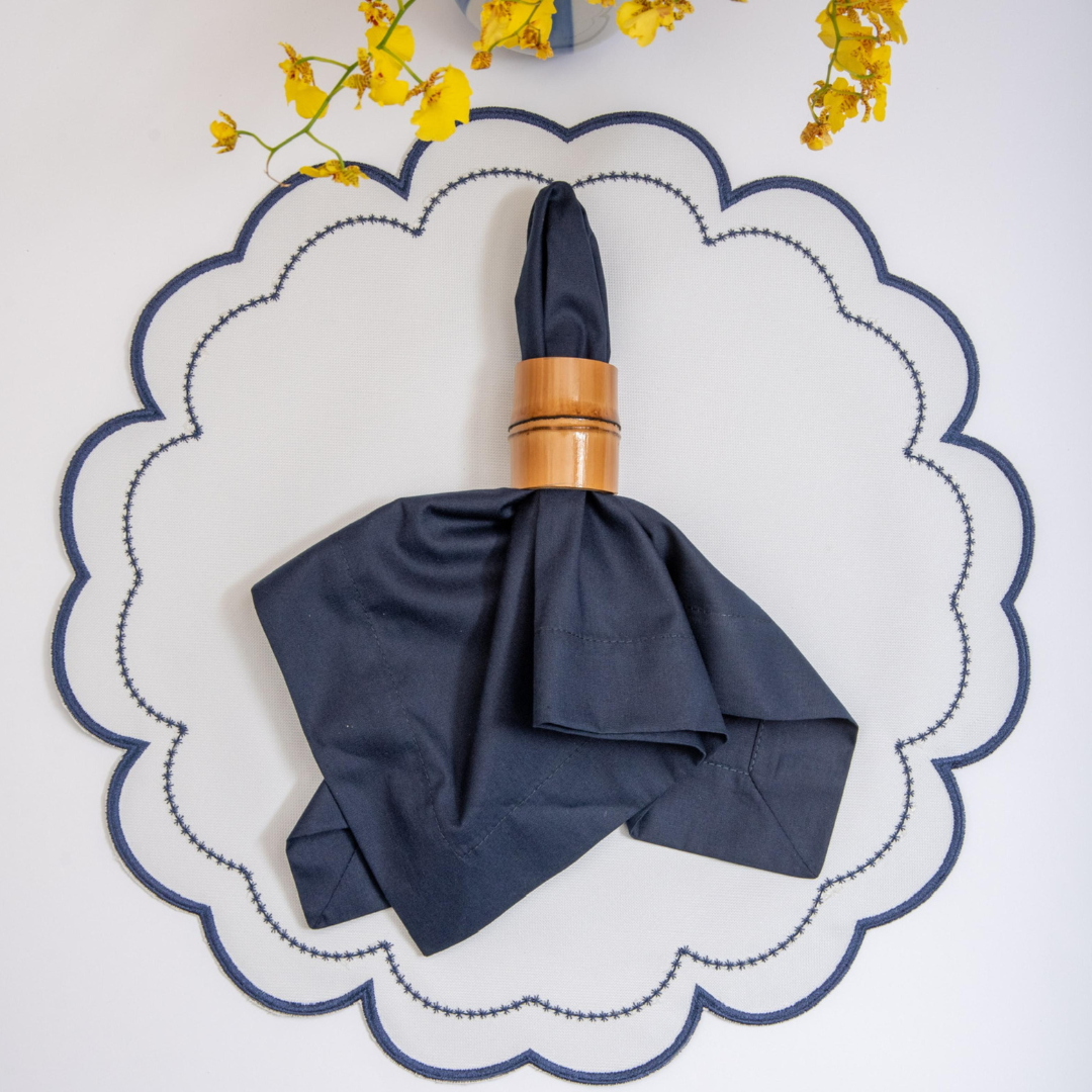 The navy Victoria impermeable placemat with Victorian-style border detail by Talah Home
