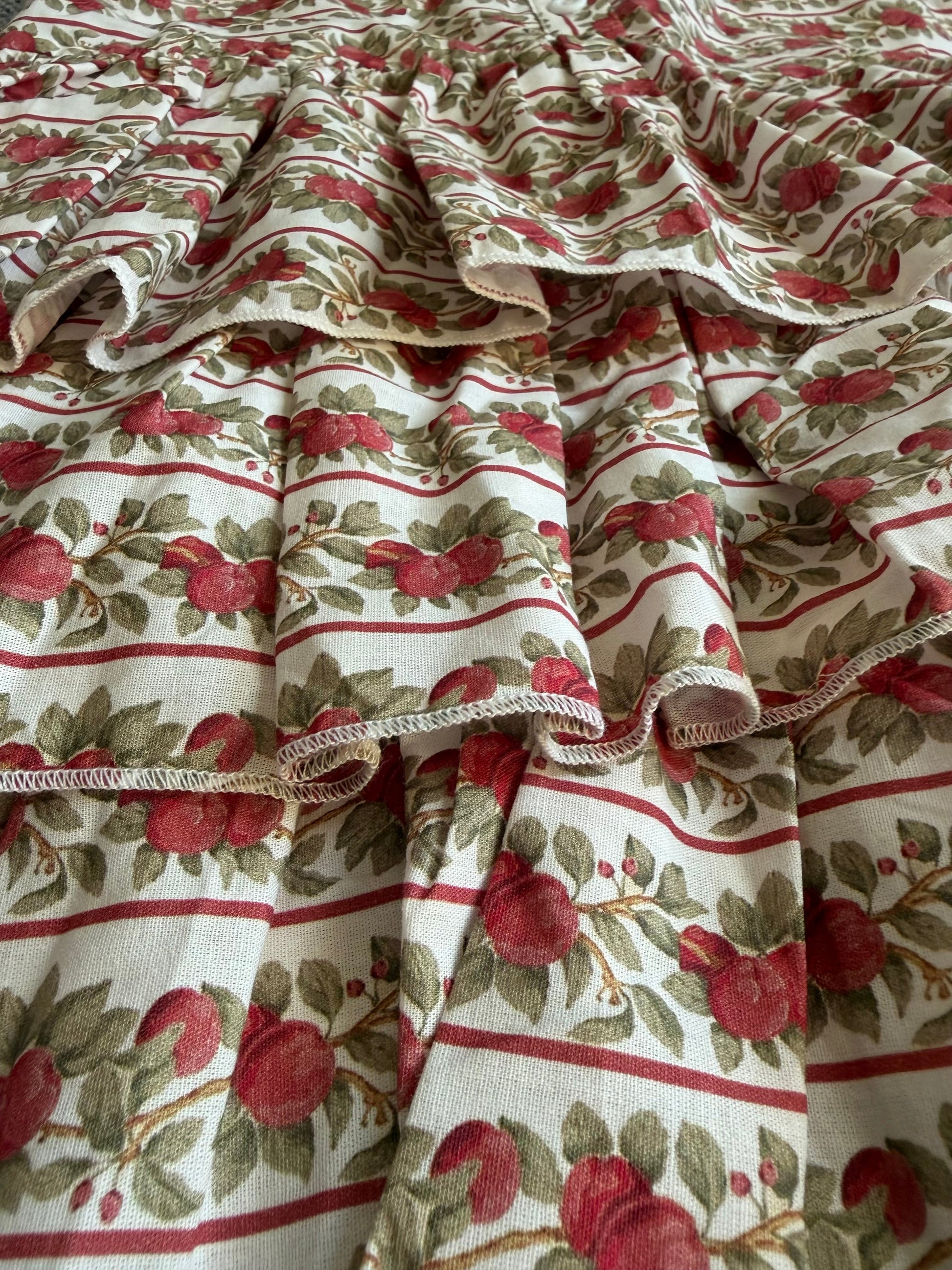 Fabric with red apple pattern and ruffled edge