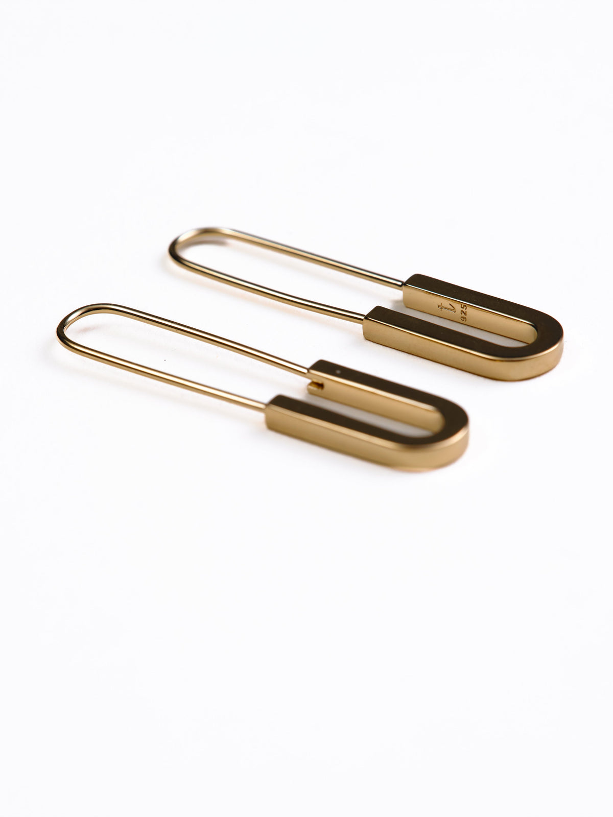 Pair of gold earrings on a white background