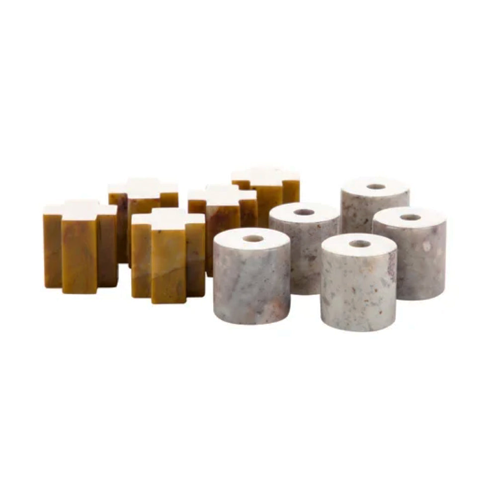 Close-up of the carved stone Tic Tac Toe pieces displaying their smooth finish on a white background.