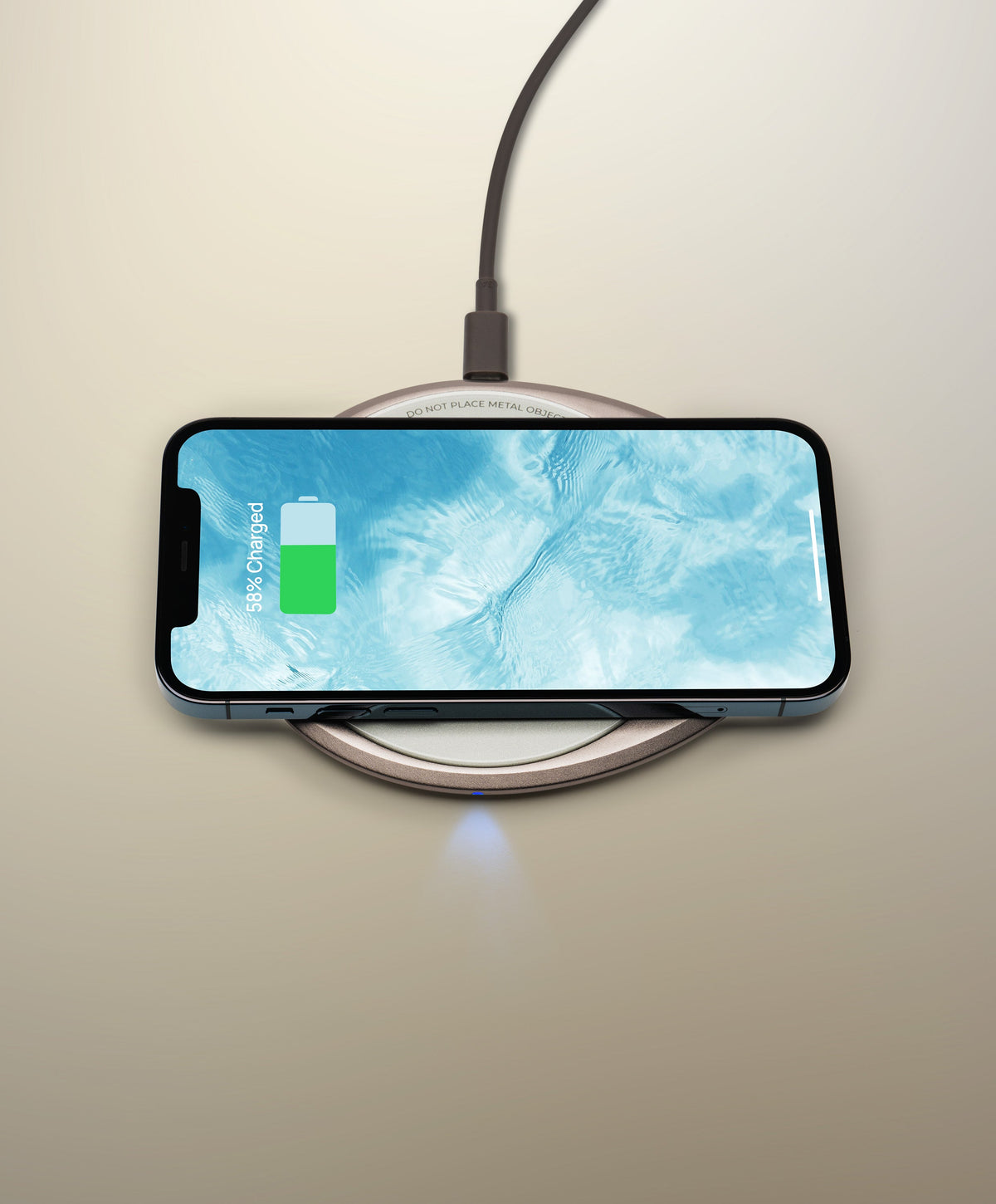 OHOM Pad 3 Cosmic Silver wirelessly charging iPhone