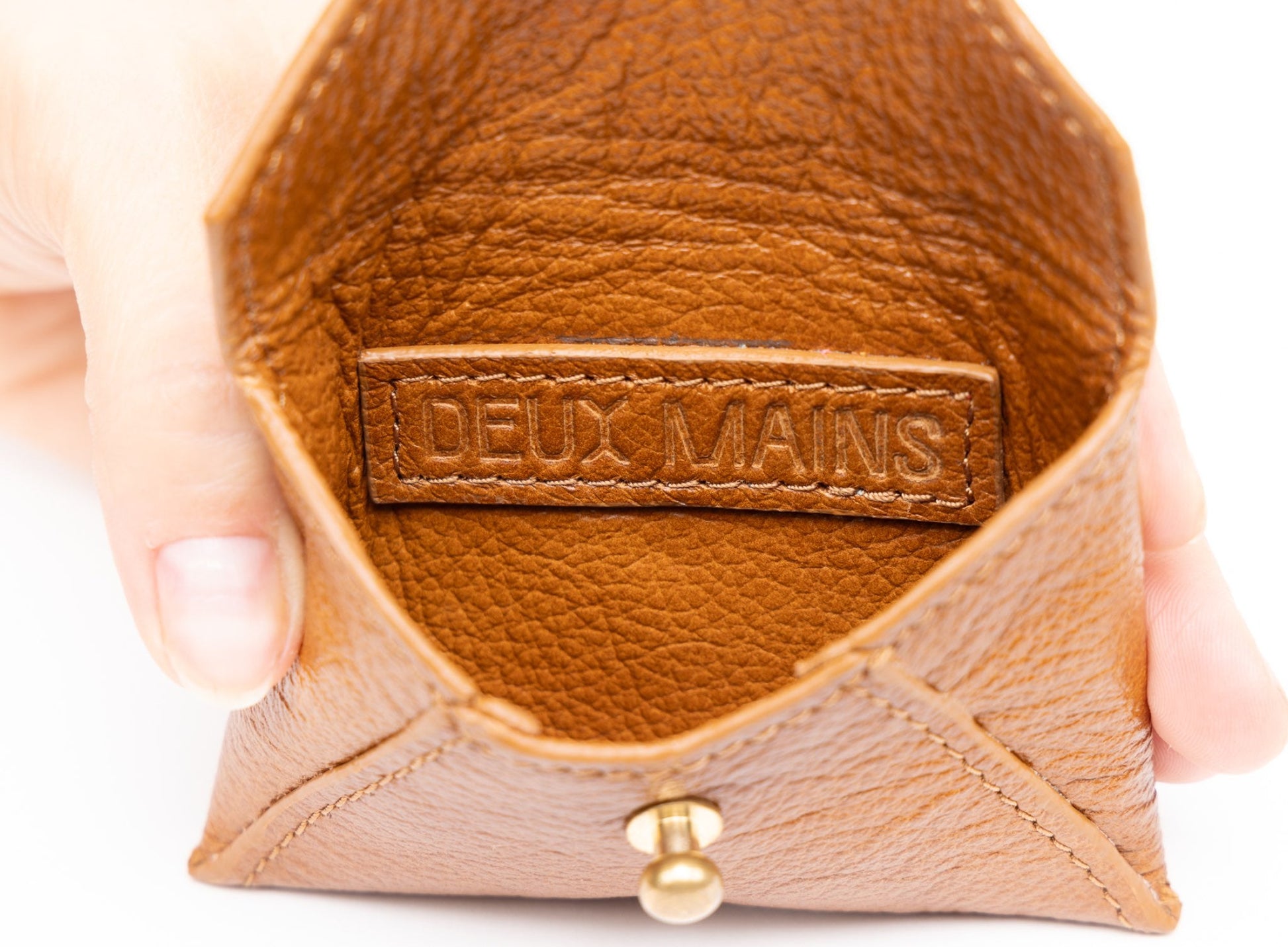coin pouch from ethically crafted accessories in cognac color showcasing interior view.