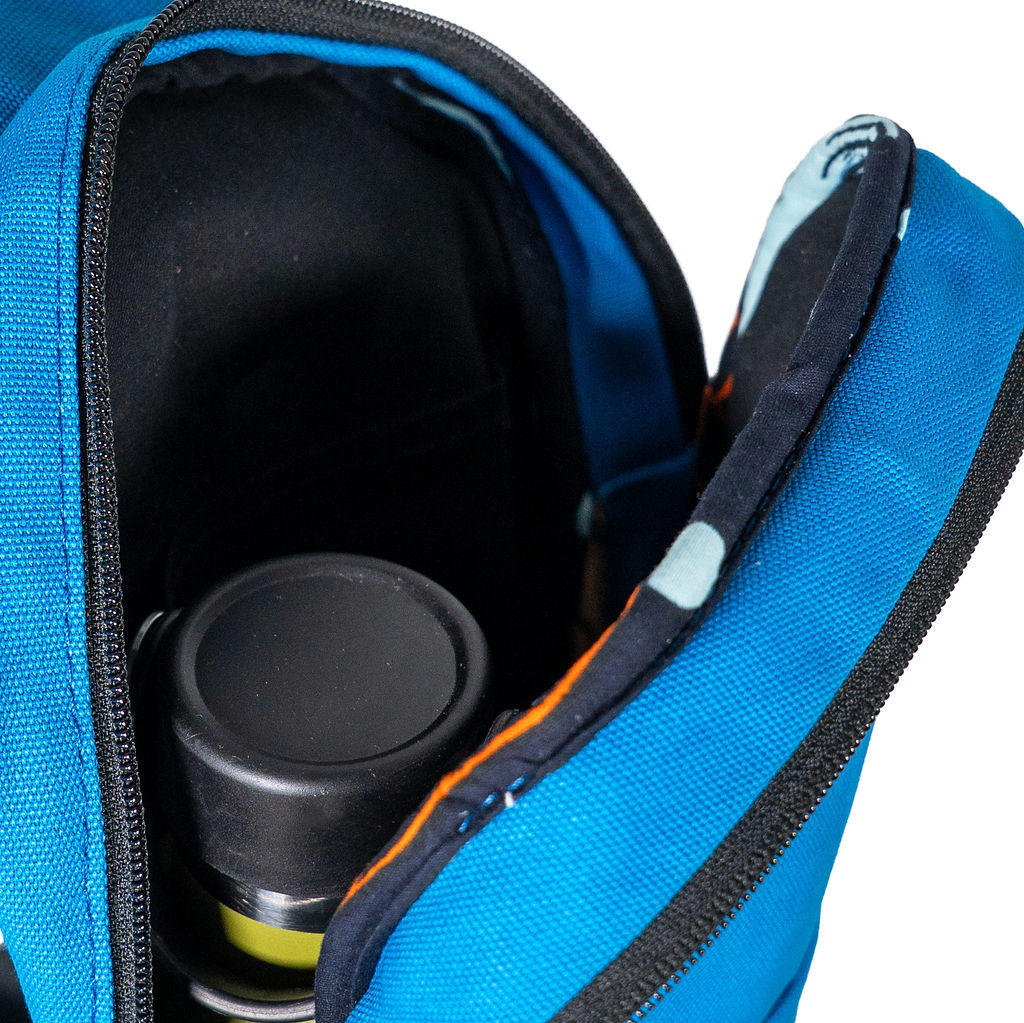 Umoja canvas sling bag in Zilly Blue worn crossbody #color_zilly-blue