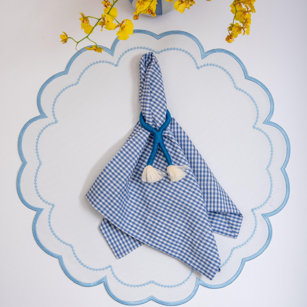 The blue Victoria impermeable placemat with Victorian-style border detail by Talah Home