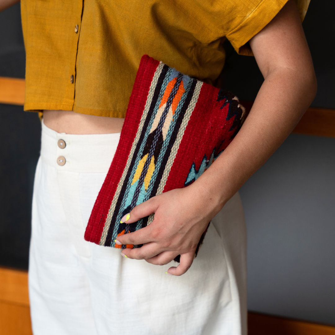 Handwoven convertible clutch with Zapotec pattern in bold colors; can be used as a pouch, wristlet, or crossbody with included leather straps and internal pocket.