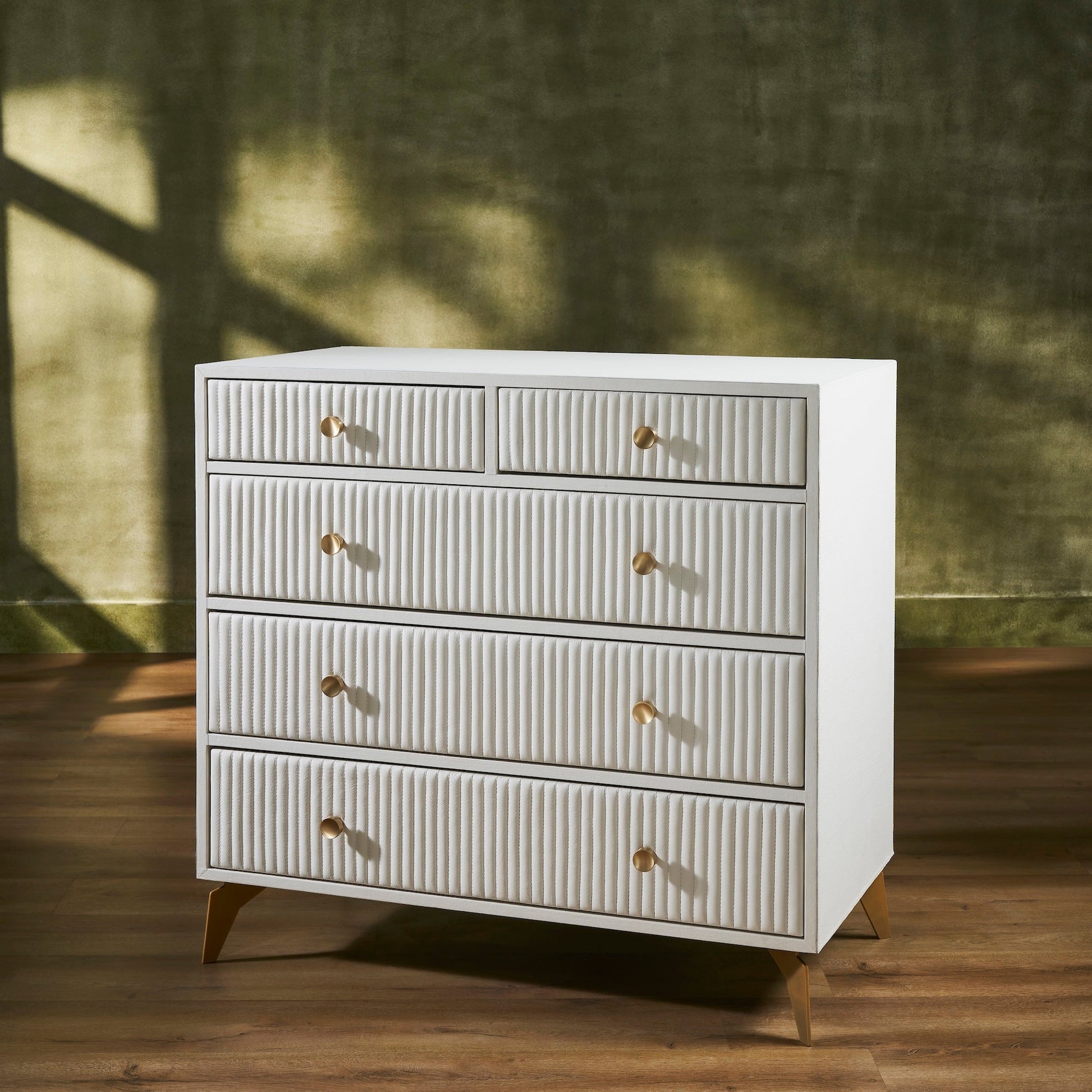 FN-5216-482036_2|Stylish cream ribbed leather dresser with golden pulls and tapered legs, a contemporary piece for spacious bedroom storage.