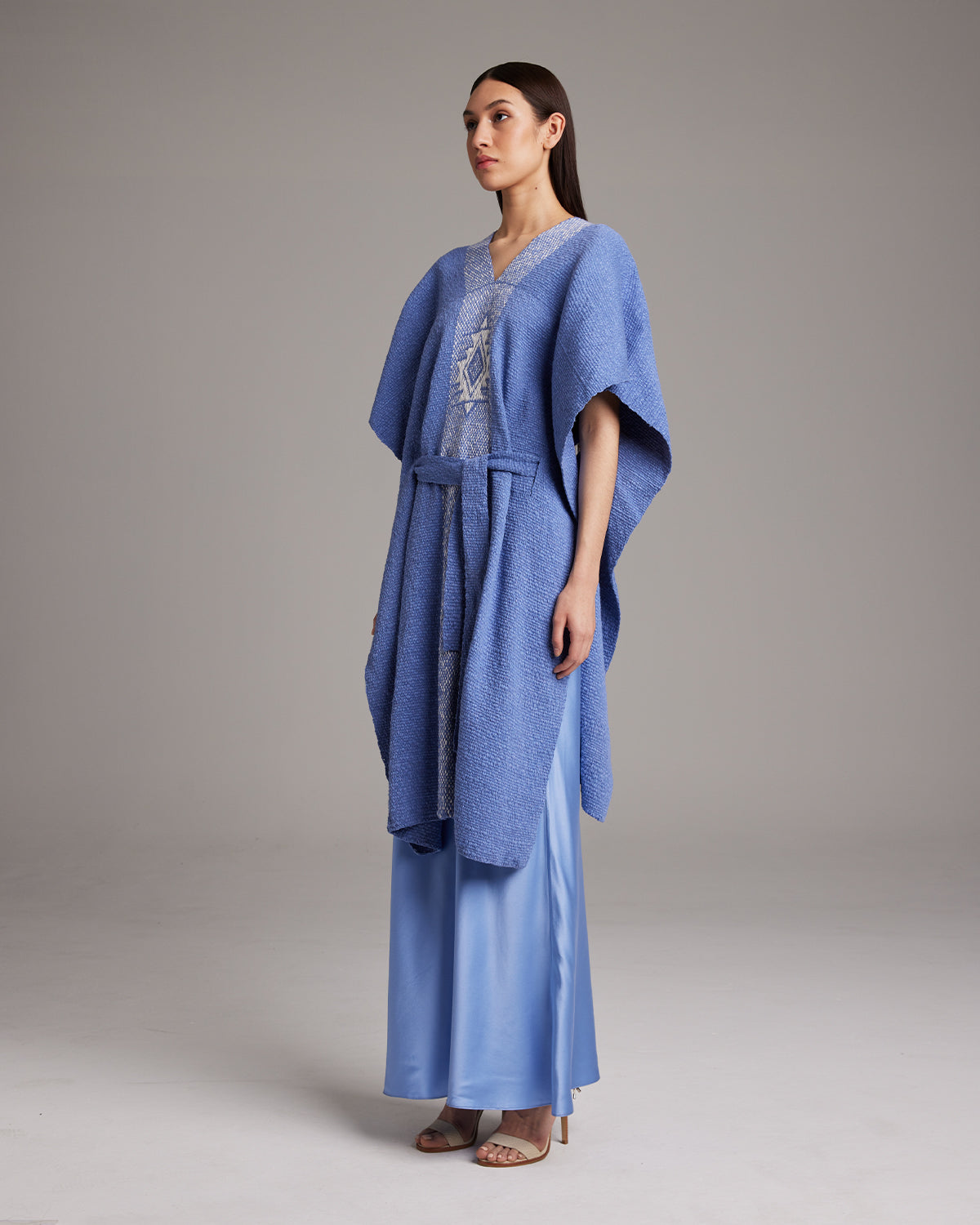 Model wearing a blue Estrella Kaftan with a long satin skirt