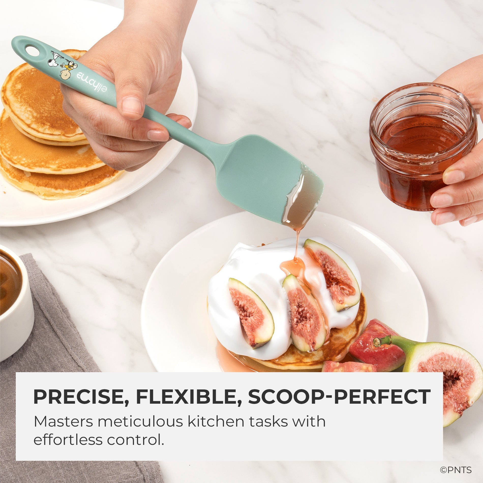 Person using a silicone spatula to serve pancakes with figs and yogurt, with text highlighting features.