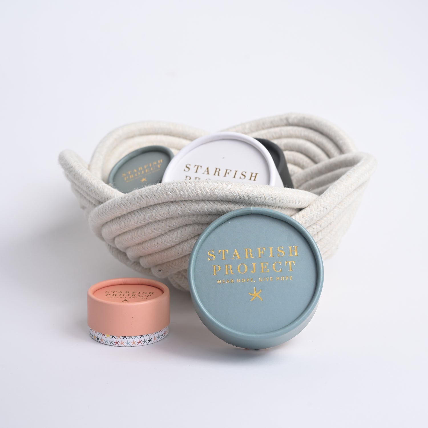 Hand woven bowl holding Starfish Project gift boxes, unique gifts for Christmas, beautiful gift packaging