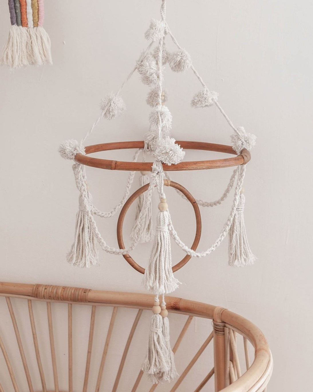 Pom Pom Baby Mobile handmade by Village Thrive using natural materials.
