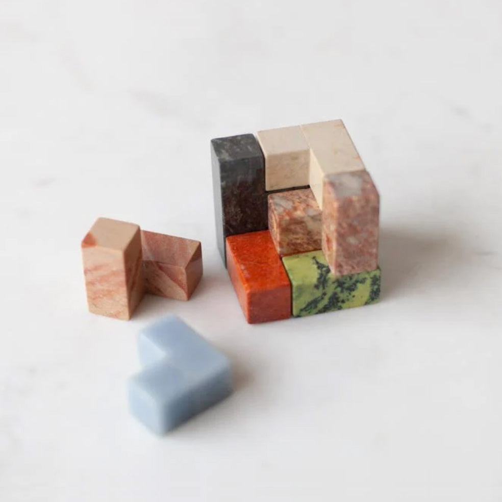 Top-down view of the assembled gemstone puzzle, revealing the subtle natural color variations and organic textures inherent to Andean materiality.