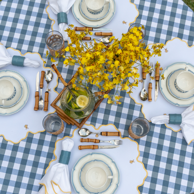 Bumble bee impermeable placemat with hand-stitched bee embroidery and yellow wavy border by Talah Home