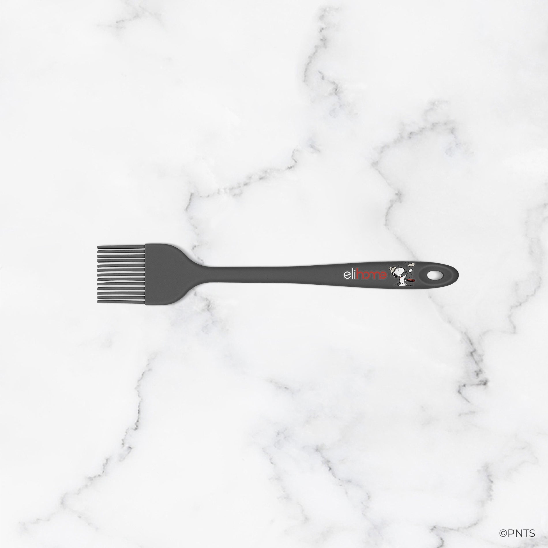 Black hairbrush with a brand logo on a marble background