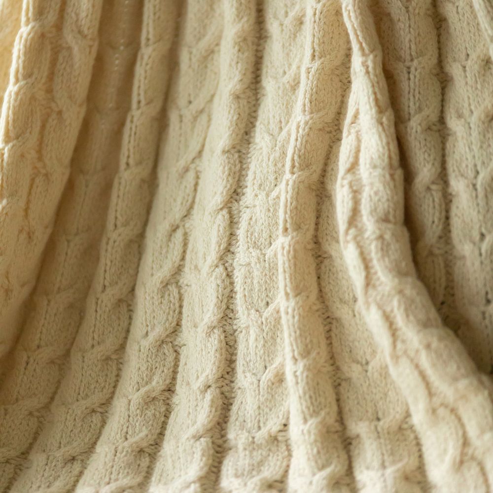 cream cable knit blanket texture close-up