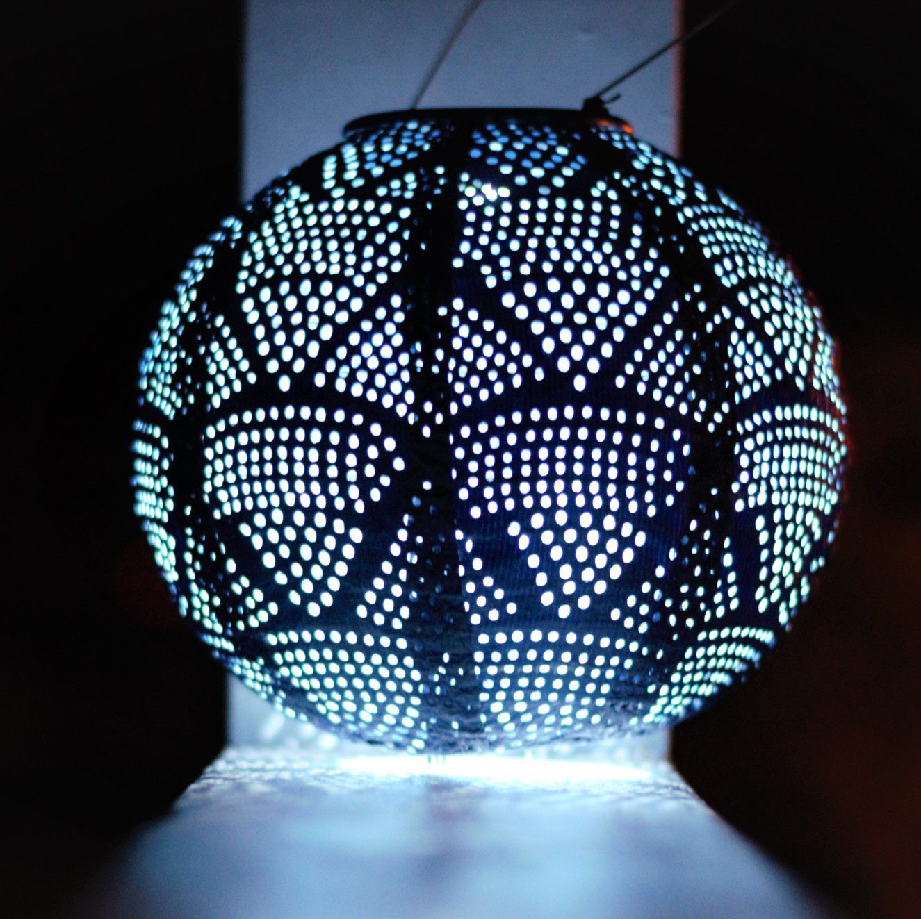 Soji Stella 8" Globe Tyvek Solar Lantern glowing at night