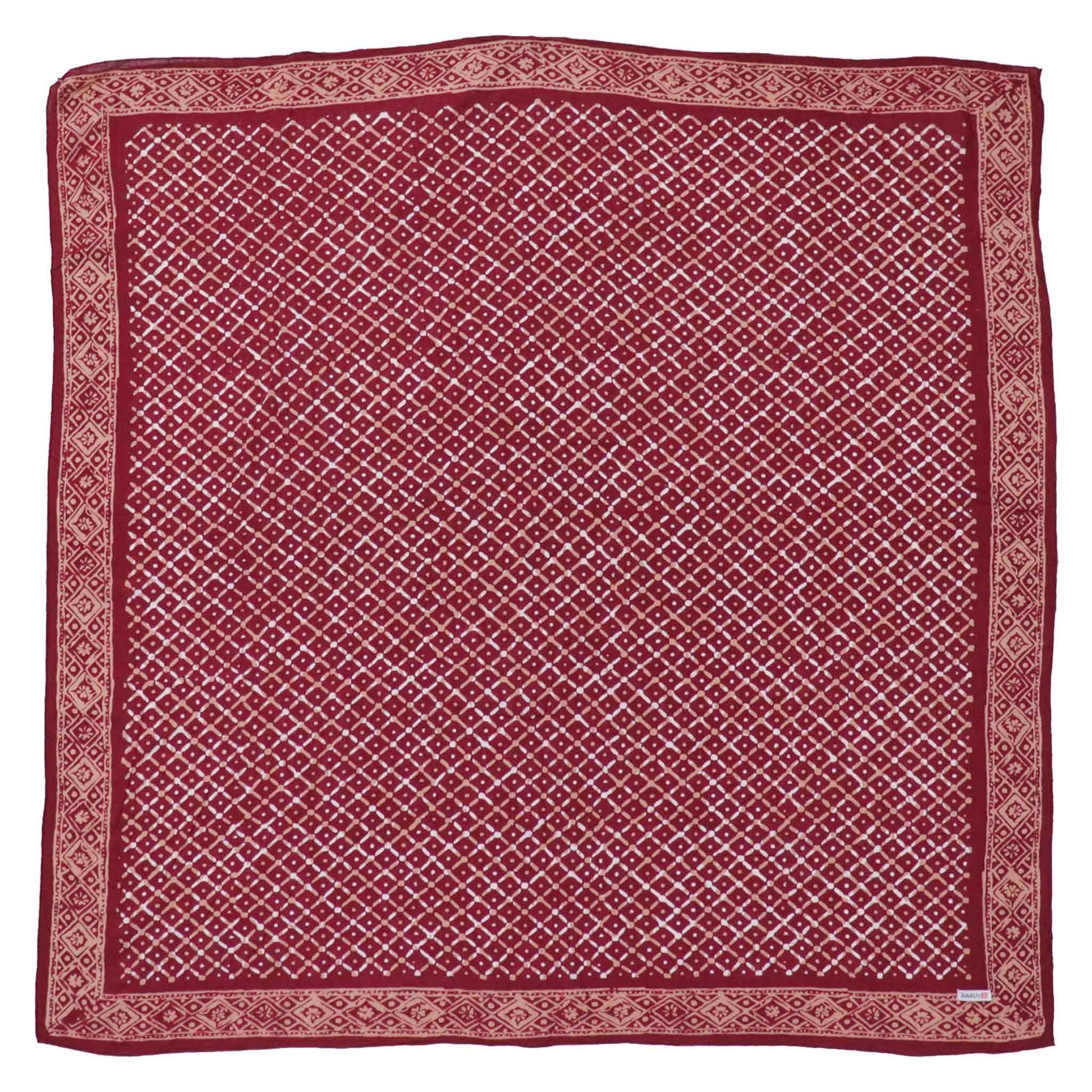 Red patterned bandana square with a visible brand label in the corner.