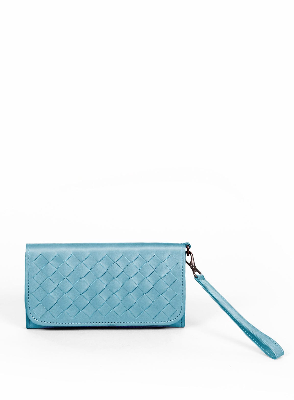 model sitting and leaning on a box holding the woven wristlets in sky blue and sage green.