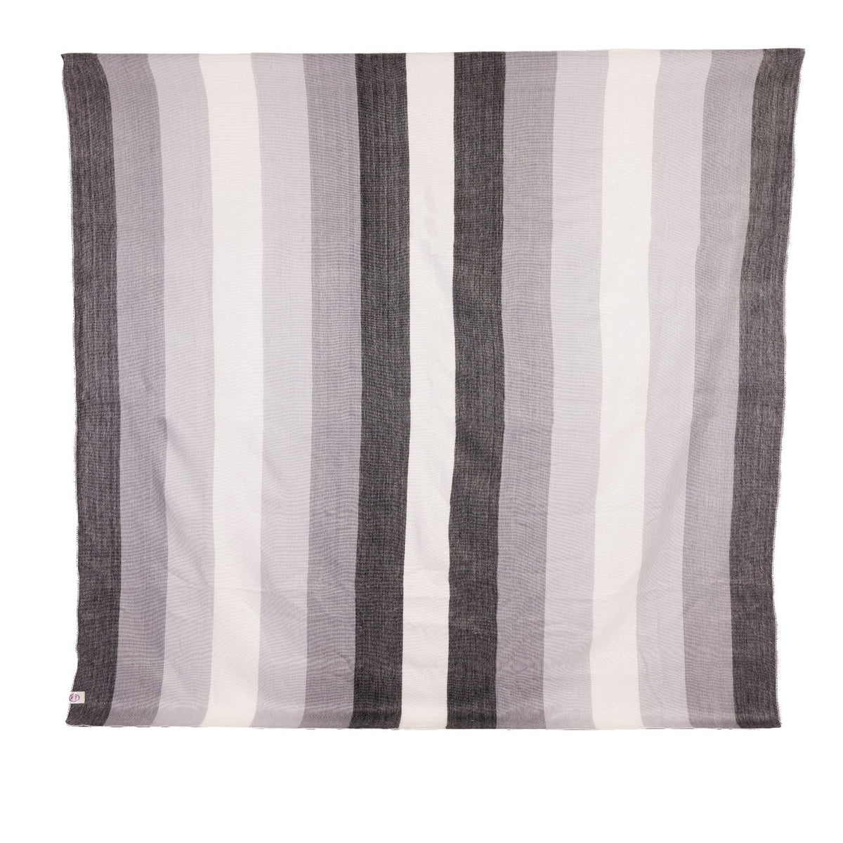 A striped throw blanket in black, gray, and white, with a visible brand tag on the lower corner.