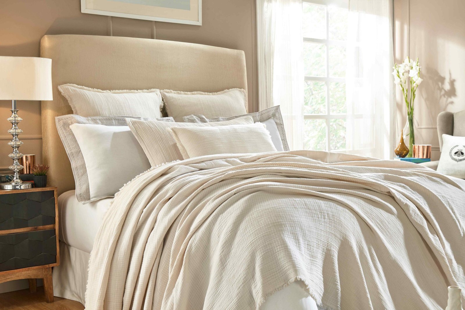 BT-103-9496_1|Cream textured blanket elegantly draped on a bed, complemented by matching pillows, creating a serene bedroom ambiance.
