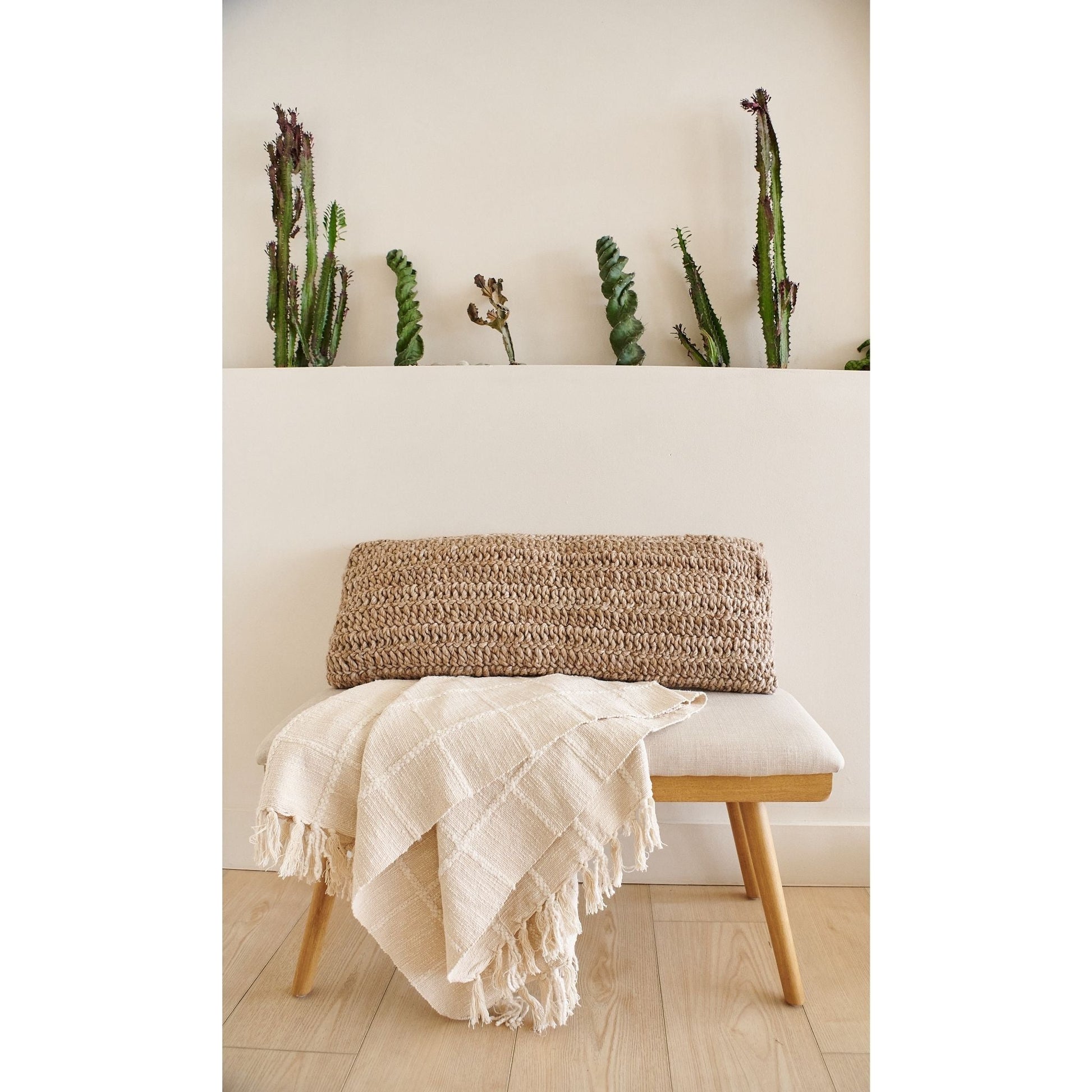 Sea Shell White Textured Checks Handloom Throw draped over a modern bench with decorative plant backdrop.