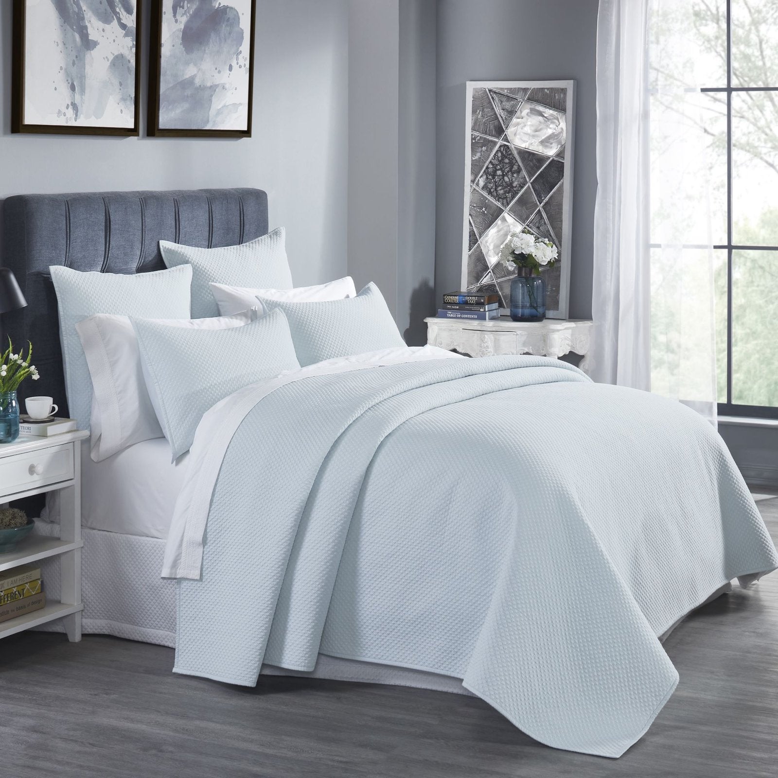 CL-251-9496_2|Light blue textured coverlet elegantly drapes a queen bed, enhancing a bright room with a peaceful ambiance.