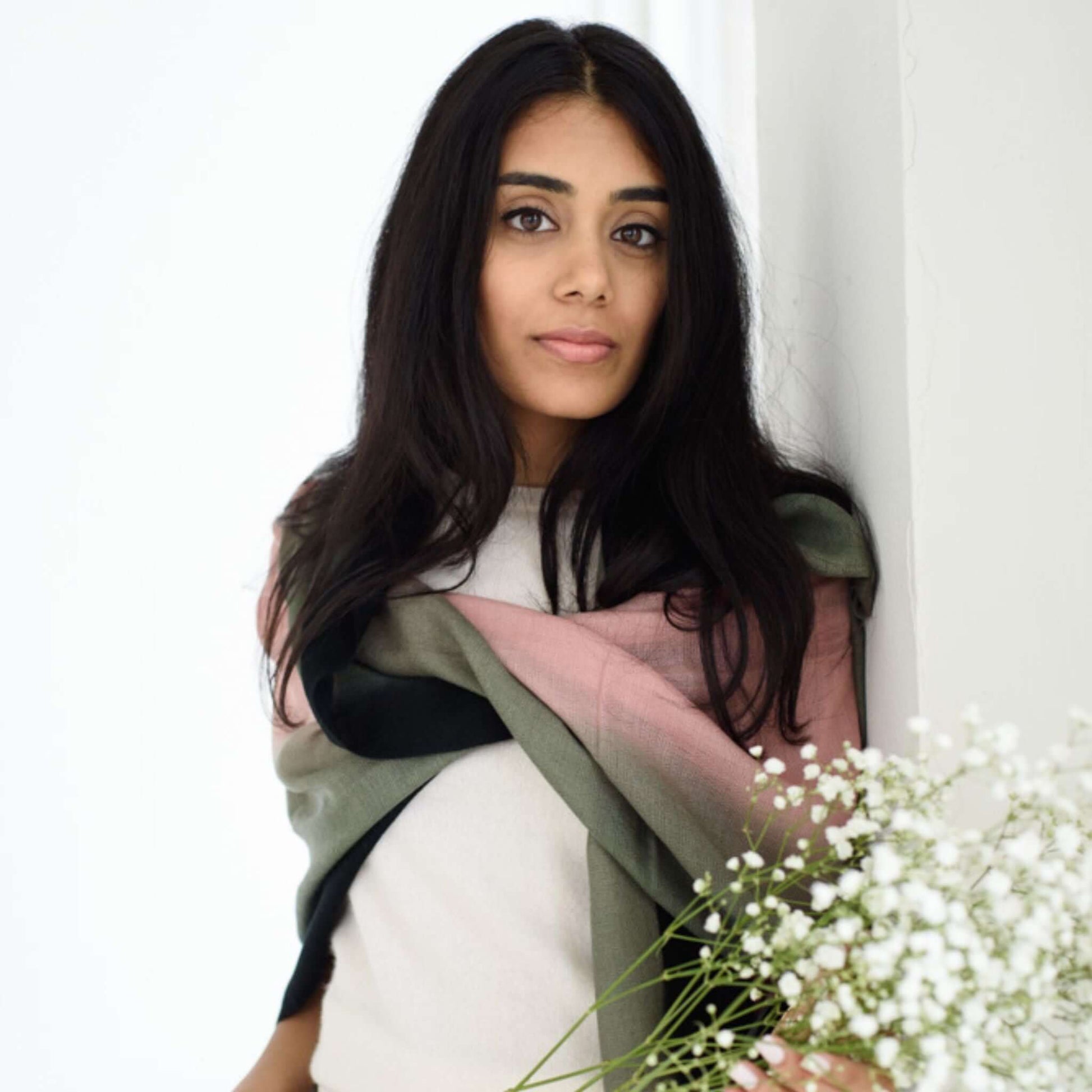 Iris Kiwi Green Pink Cashmere Merino Handwoven Scarf draped elegantly on model with flowers.