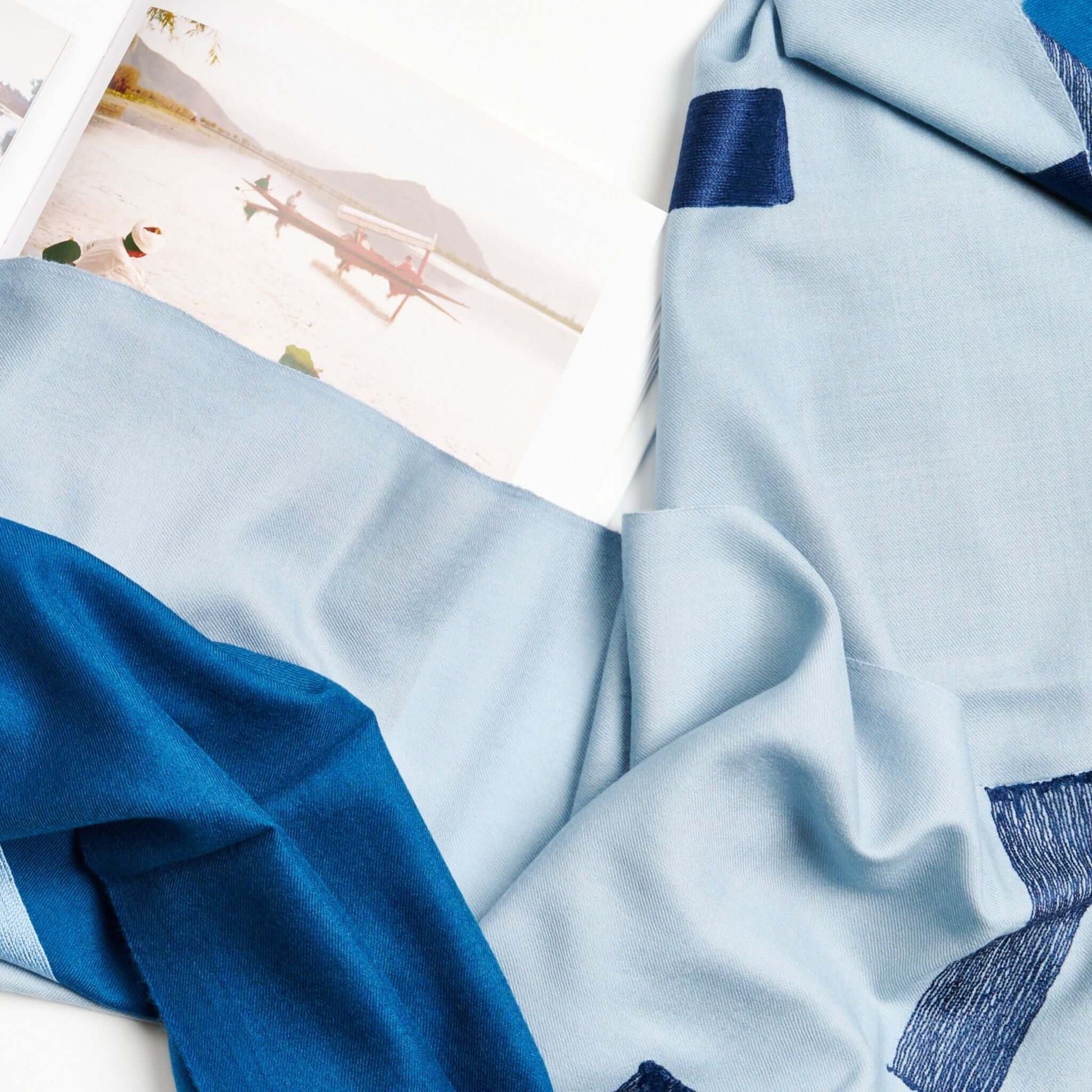Harbor Blue Silk Merino Hand Woven Hand Embroidered Modern Artisanal Scarf draped elegantly with soft textures.