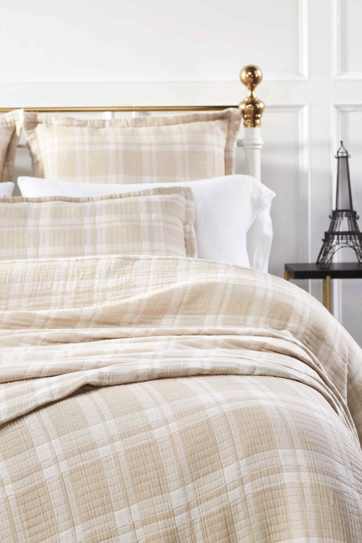 BT-118-9496_4|Close-up of a soft beige and white plaid textured cotton blanket on a bed, showcasing the fabric's soft texture and pattern.