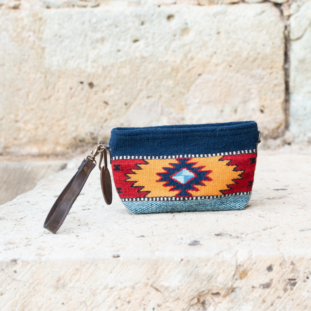 Handwoven convertible clutch with Zapotec pattern in bold colors; can be used as a pouch, wristlet, or crossbody with included leather straps and internal pocket.