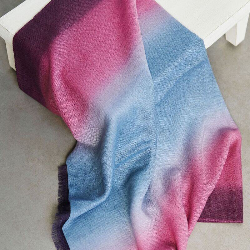 Iris Haze Blue Pink Cashmere Merino Handloom Scarf draped elegantly on a table, showcasing soft blended colors.