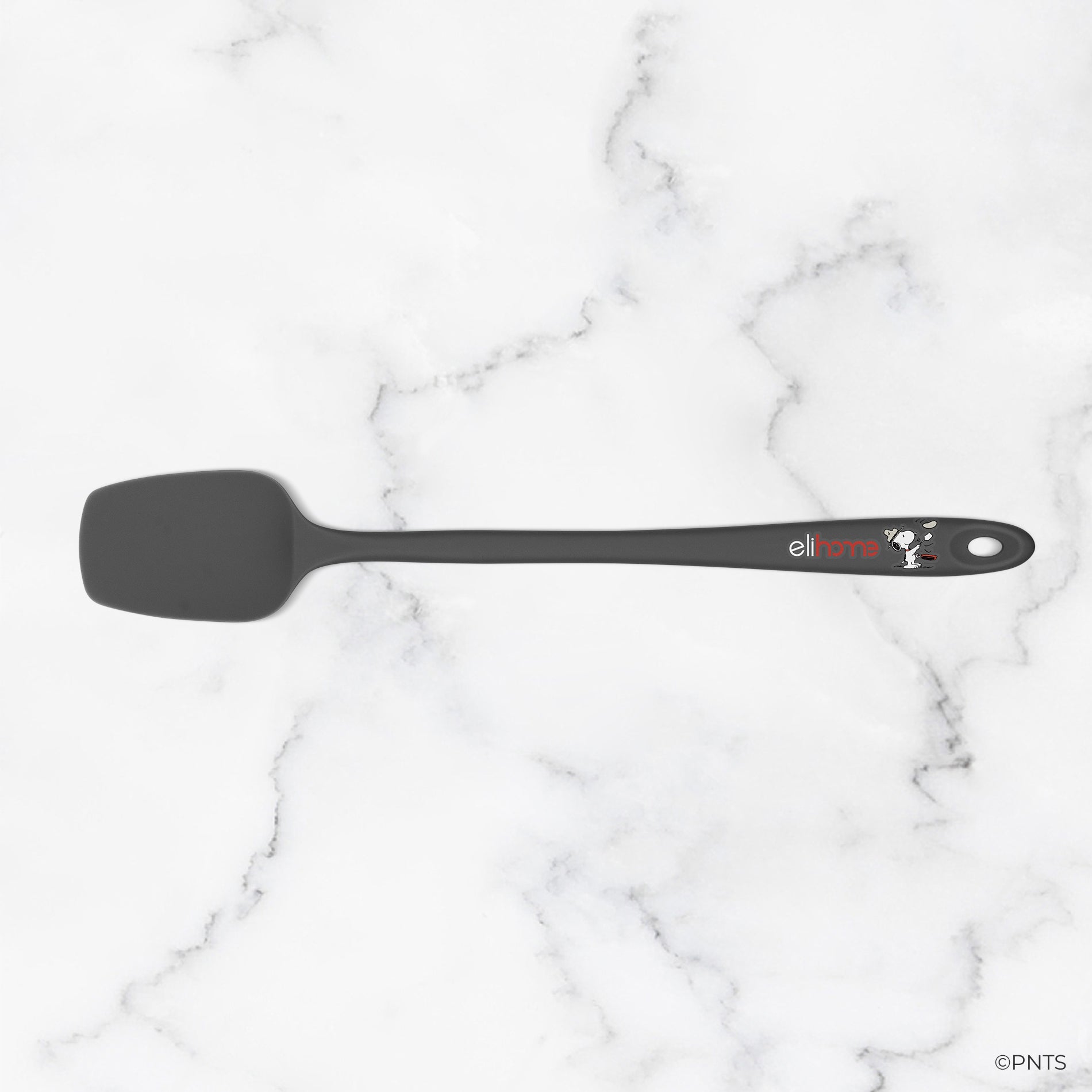 Black spatula on a white marble surface