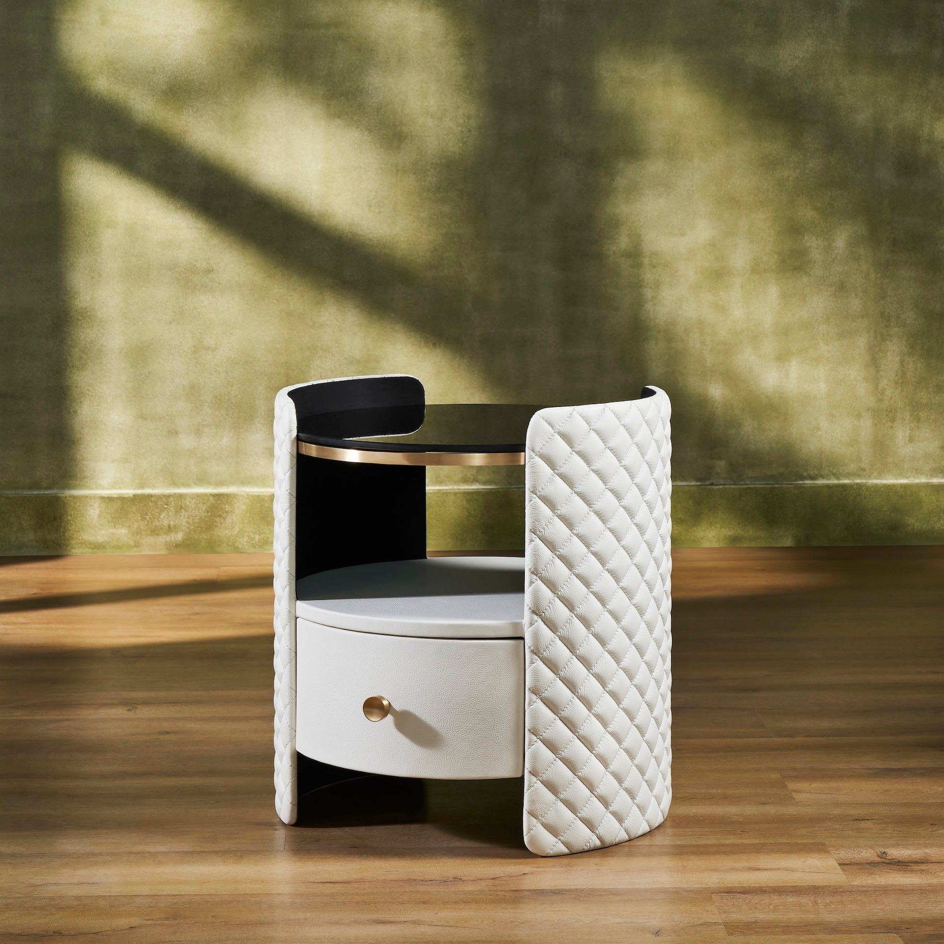 FN-5214-202022_2|White leather nightstand featuring diamond-quilted curved sides, a round black glass top, and one drawer with a gold-toned knob.