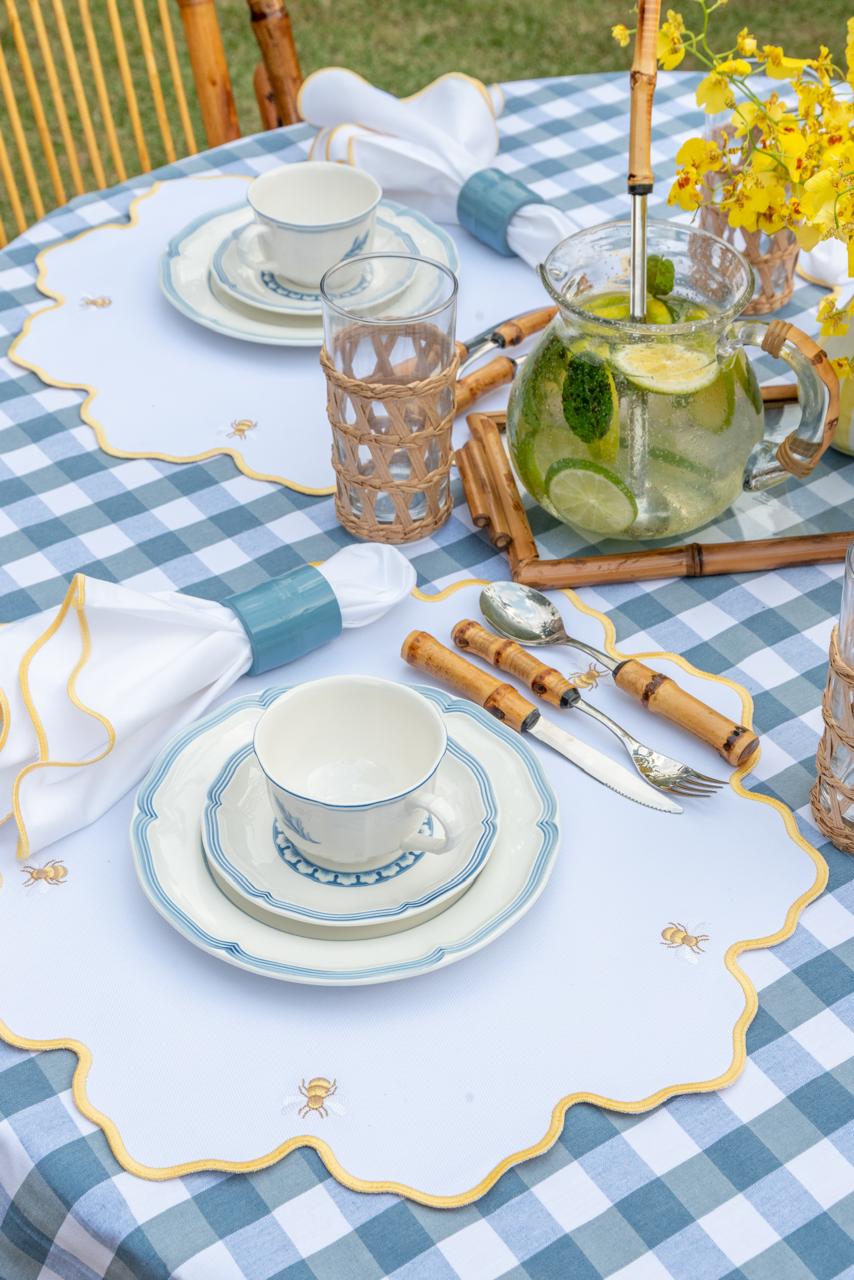 Bumble bee impermeable placemat with hand-stitched bee embroidery and yellow wavy border by Talah Home