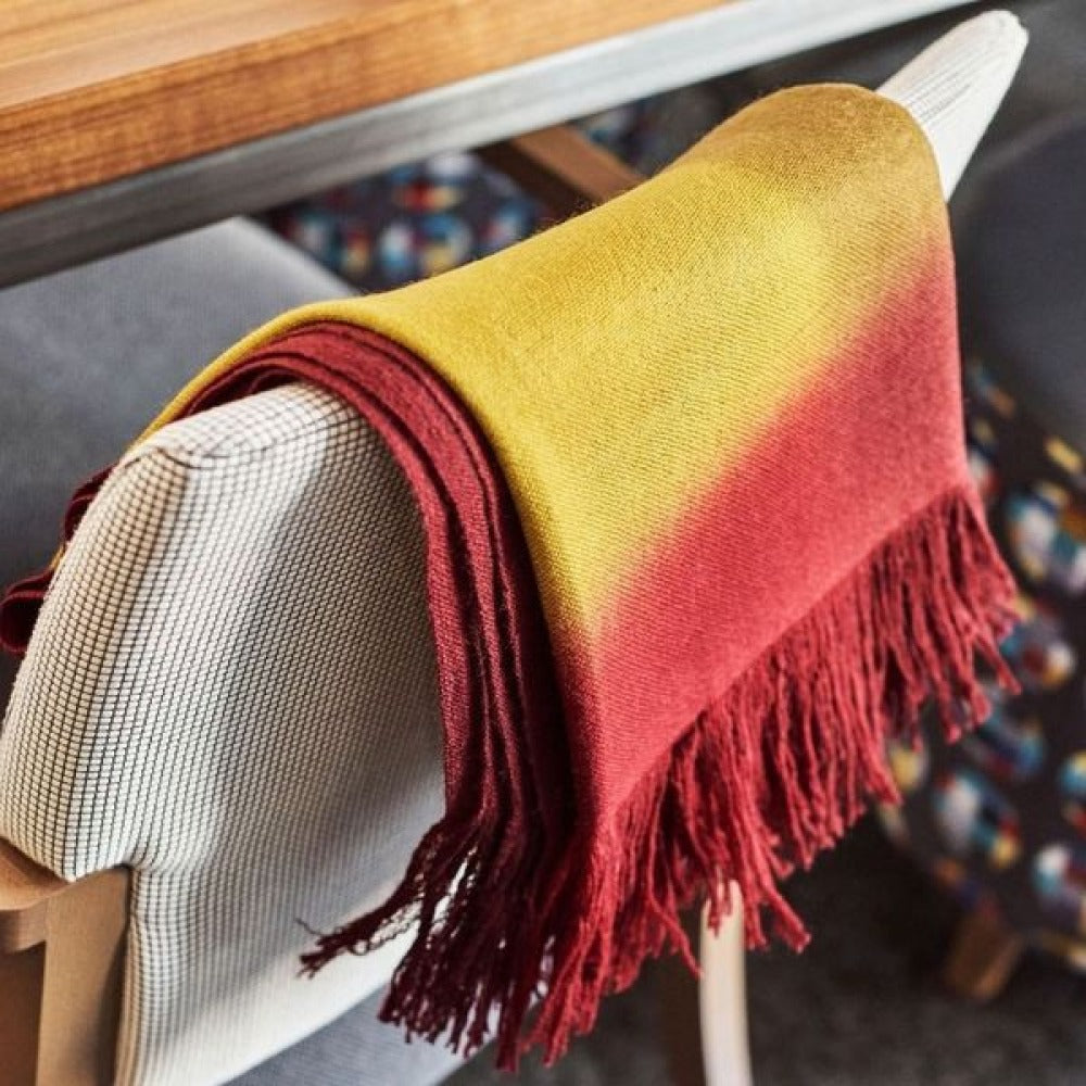 Marigold Merino Ombre Handloom Throw / Blanket Scarf showcasing its vibrant ombre design and hand-rolled fringes.