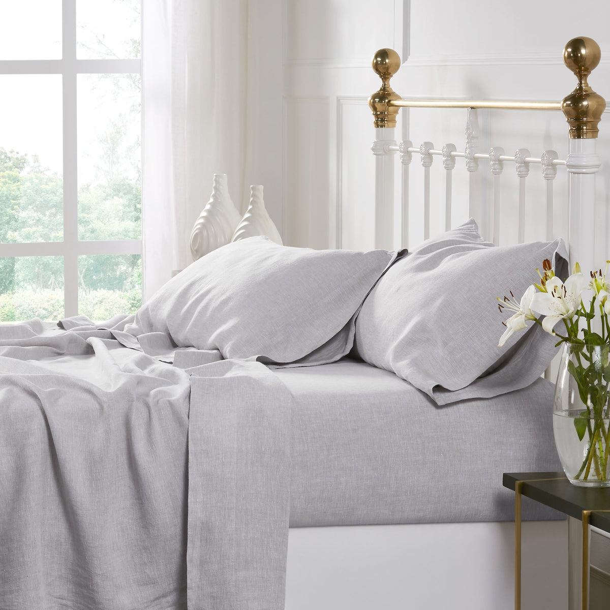 QSS-516-6080_2|Relaxed light grey 100% linen sheets on a bed, showcasing their natural drape and breathable comfort. Ideal for serene sleeping.
