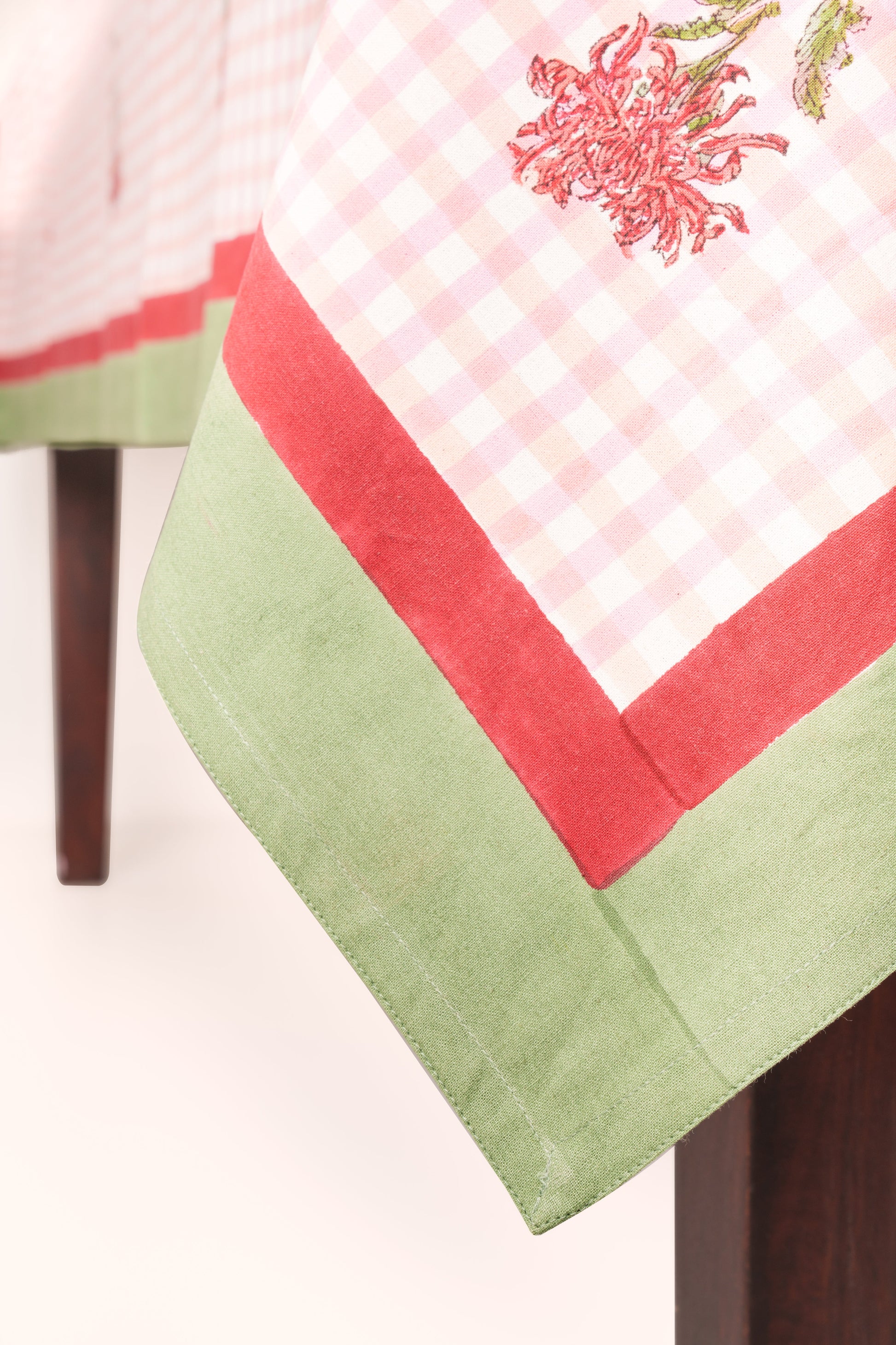 Corner of pink gingham tablecloth with red border and green trim - Inner Child