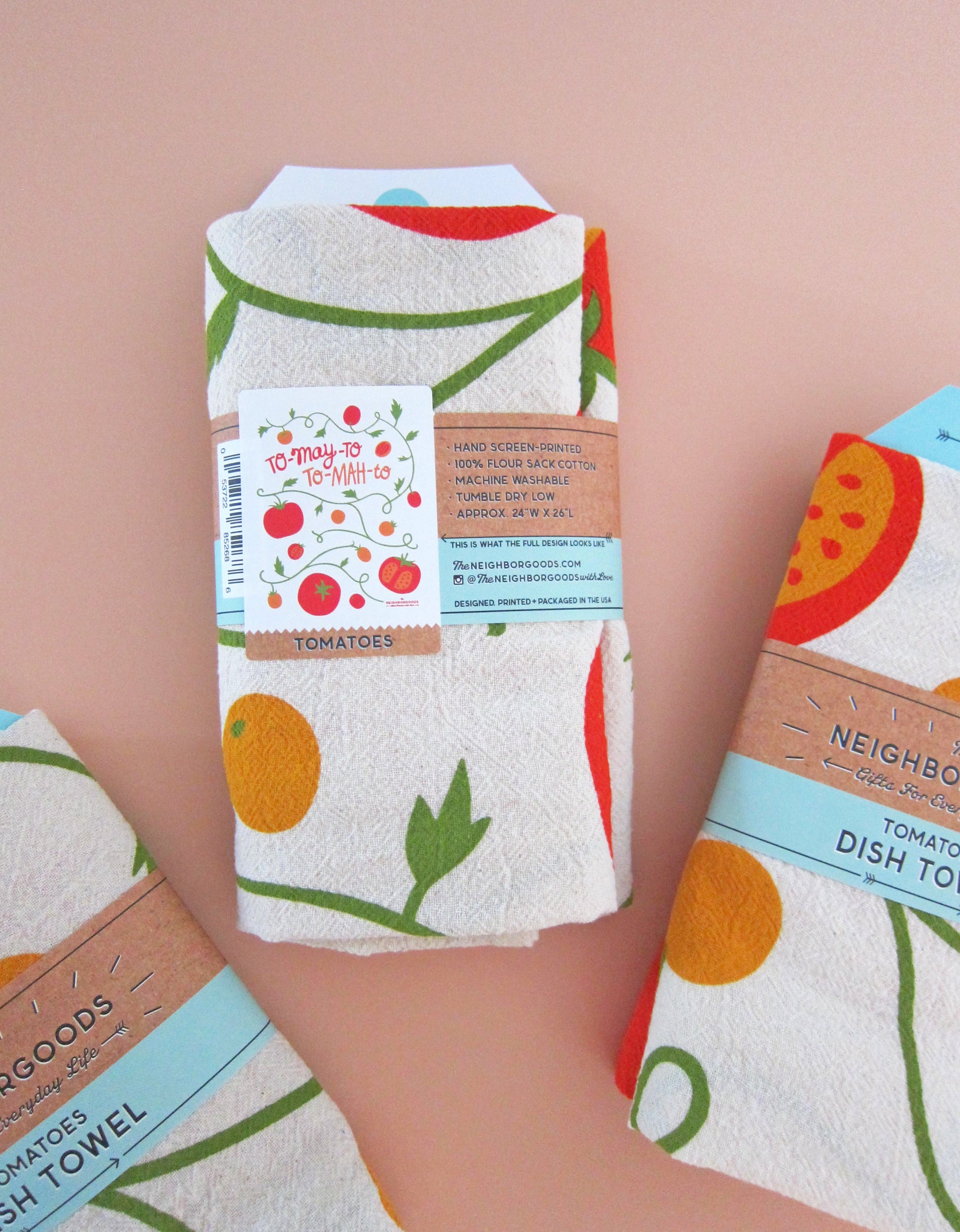 Back view of tomato dish towel packaged in branded belly bad sleeve