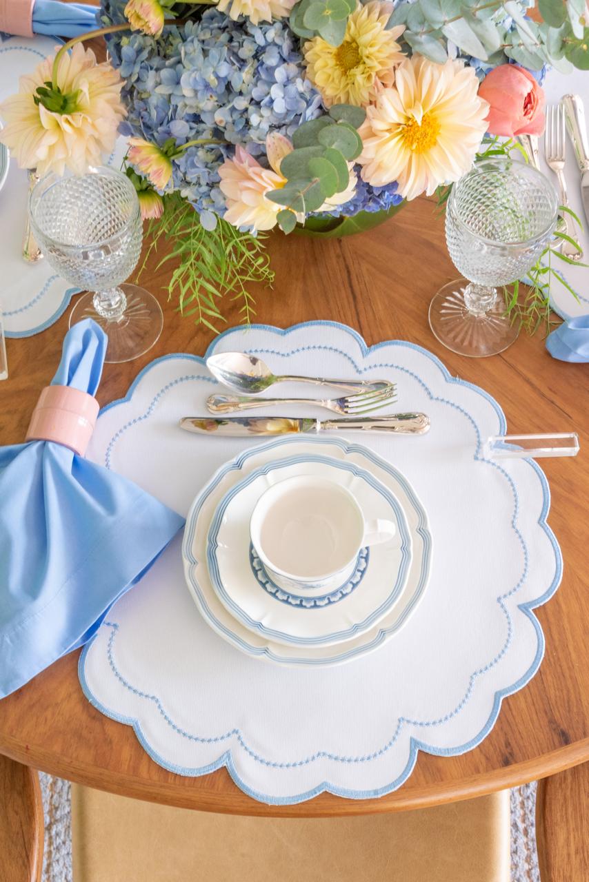 The blue Victoria impermeable placemat with Victorian-style border detail by Talah Home