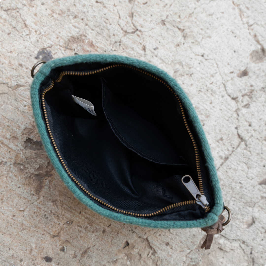 Interior view of handwoven convertible clutch with Zapotec pattern in bold colors; can be used as a pouch, wristlet, or crossbody with included leather straps and internal pocket.