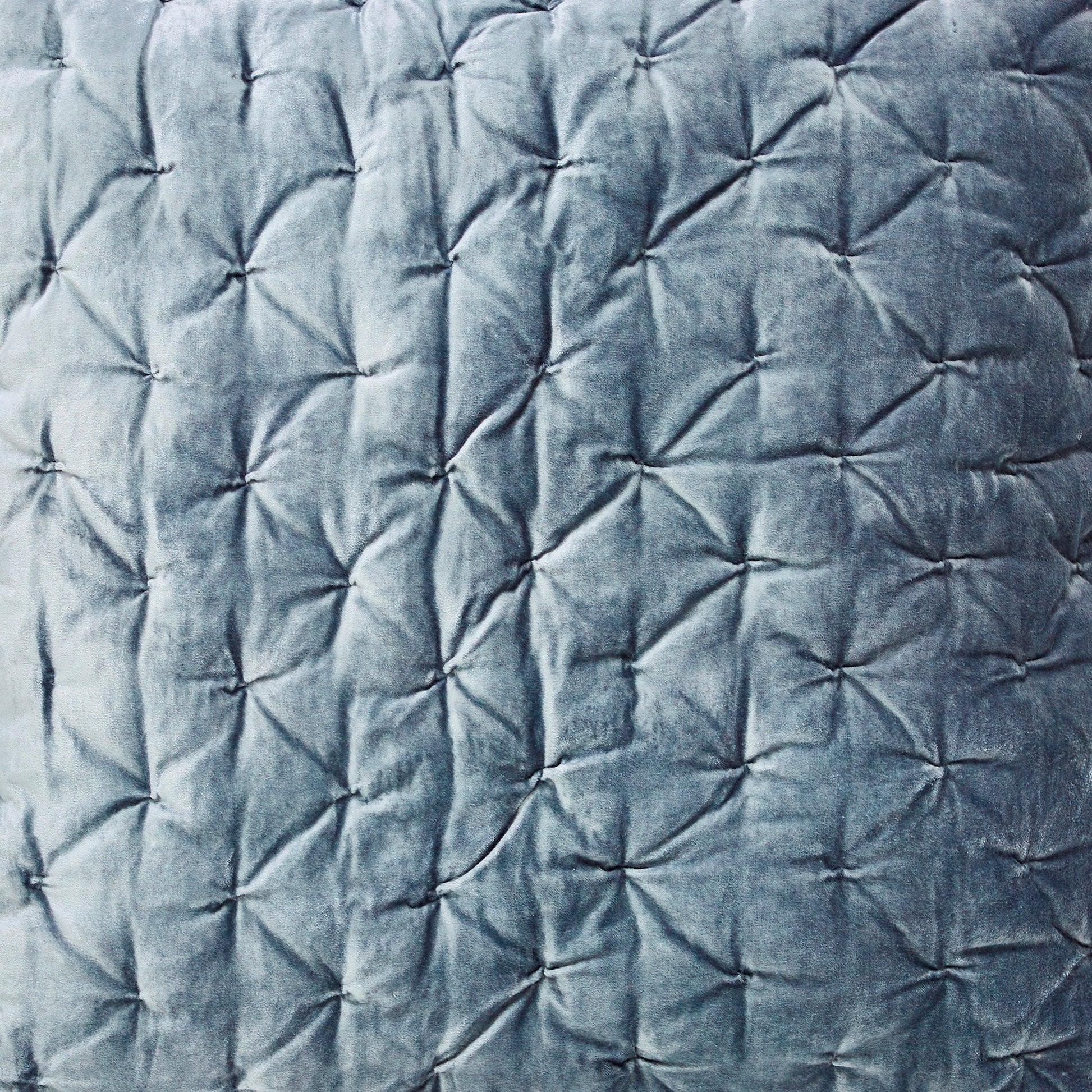 ES-336-2626-LOT1_2|Close-up of dusty blue velvet quilt fabric, showcasing a unique geometric starburst stitch pattern for luxurious texture.
