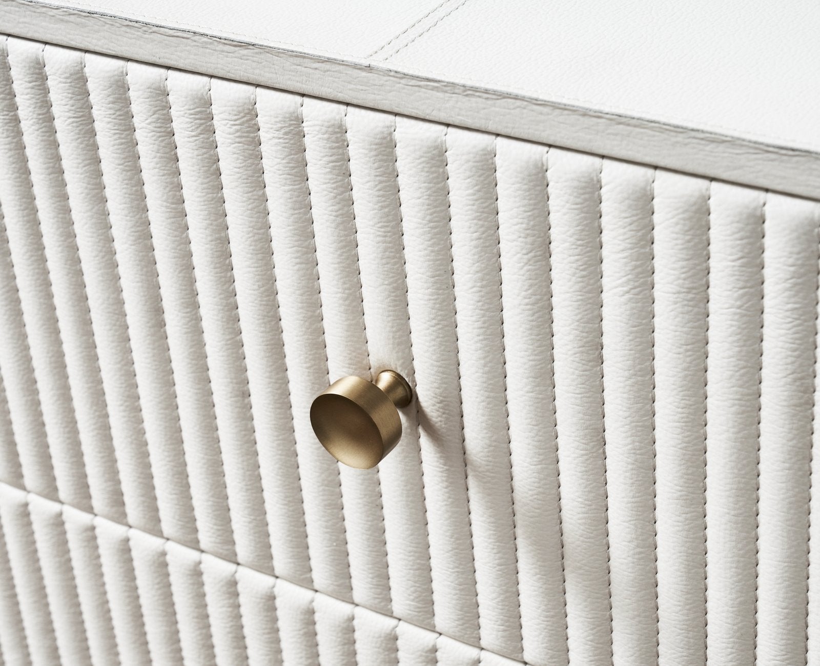 FN-5203-201828_6|Detailed close-up of luxurious white ribbed leather furniture with elegant gold round drawer pull, enhancing modern decor.