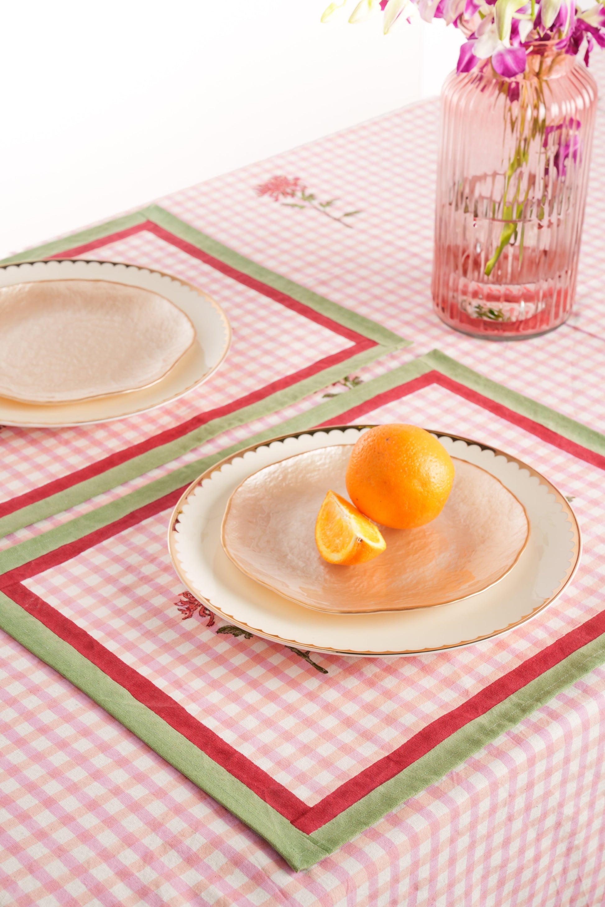 Dahlia gingham placemats on table setting, plates, orange slice & vase - Inner Child