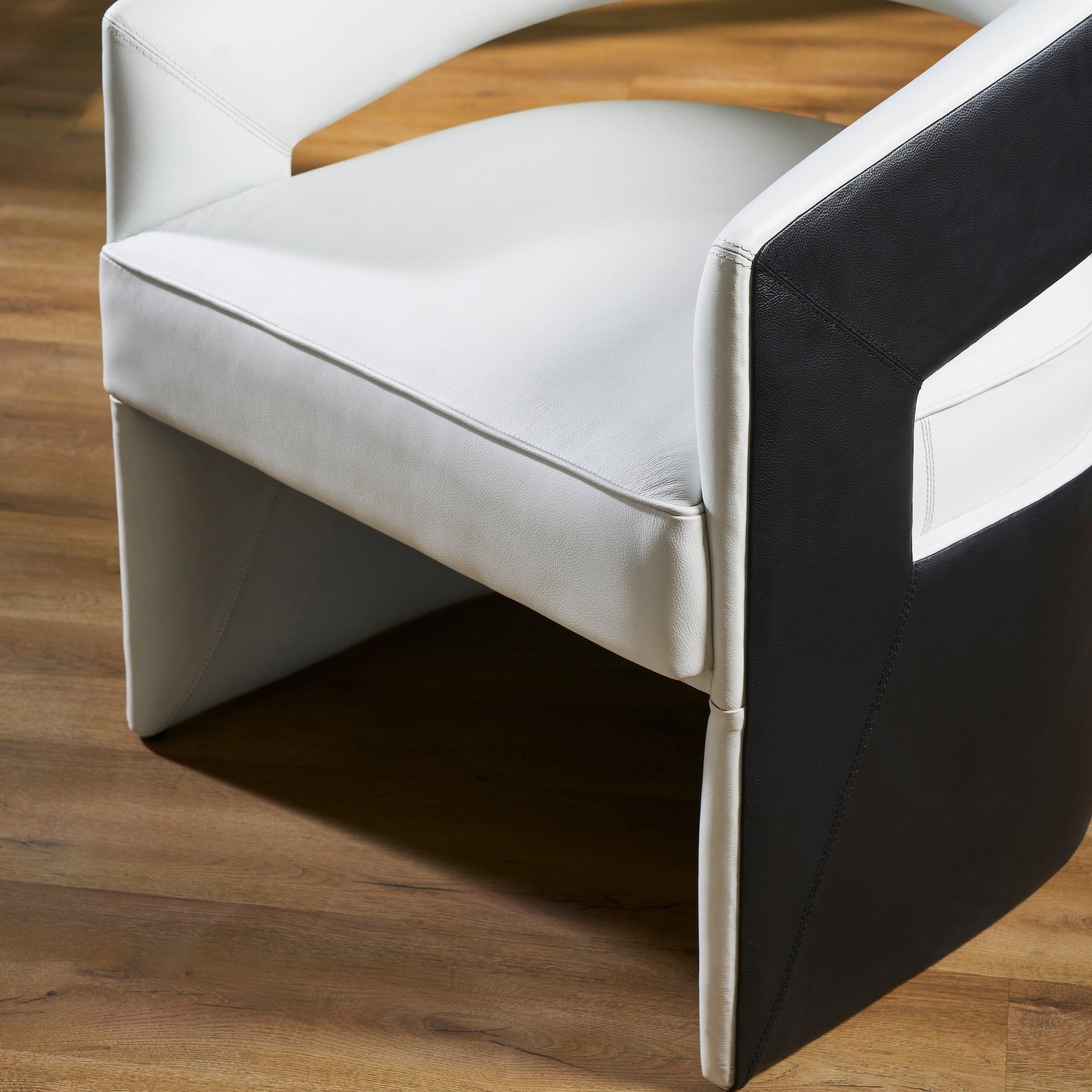 FN-5208-282429_6|Close-up of a stylish white and black leather accent chair, emphasizing the intricate stitching details and genuine leather texture.